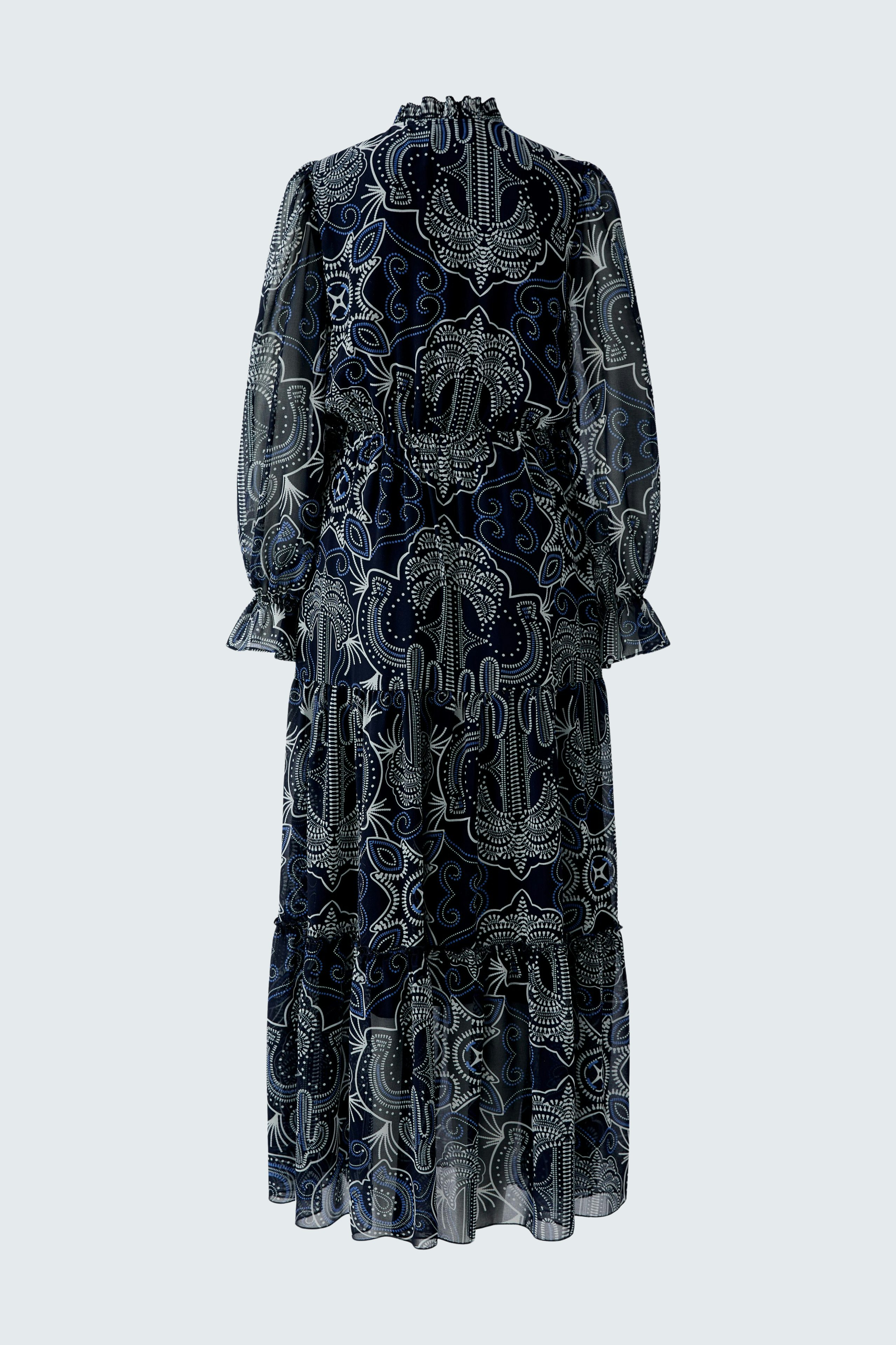 Maxi dress: A woman in a flowing navy dress with intricate patterns and long sleeves.