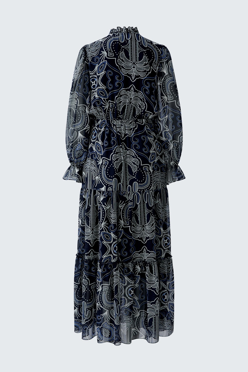 Maxi dress: A woman in a flowing navy dress with intricate patterns and long sleeves.