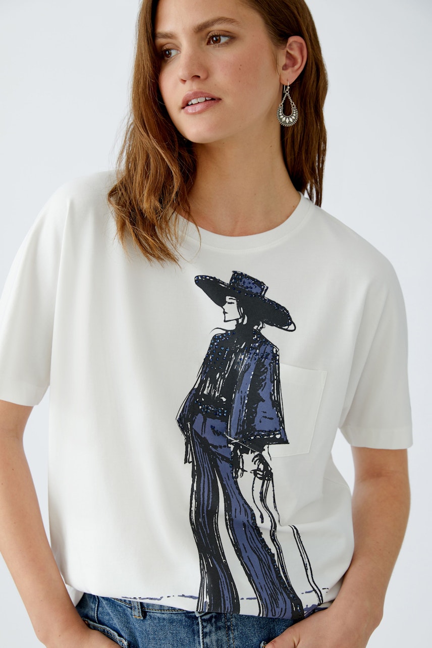 Casual women's T-shirt: Woman in a white tee featuring a stylish graphic design.