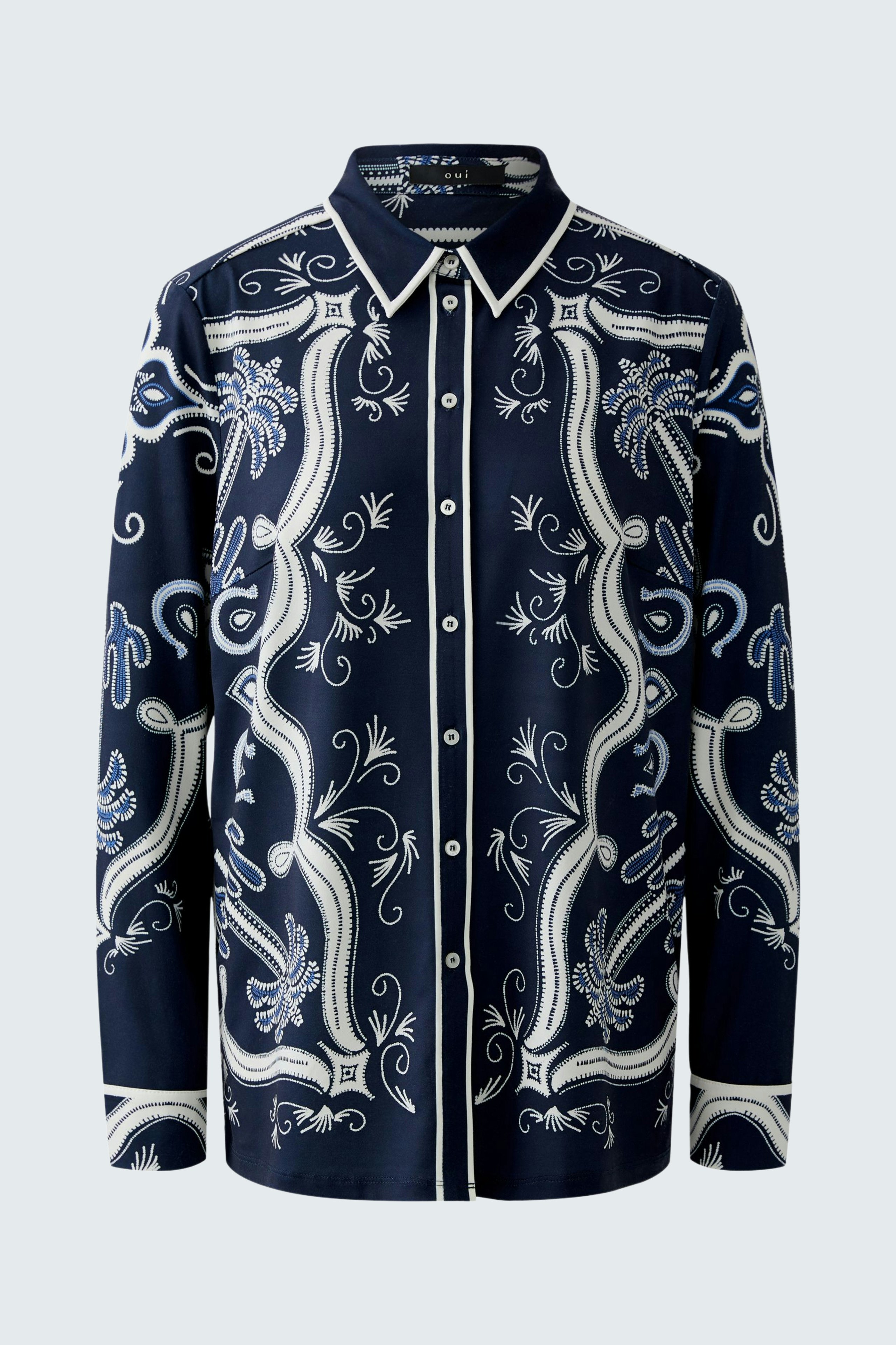 Stylish women's blouse: A navy shirt with intricate white patterns, perfect for casual wear.