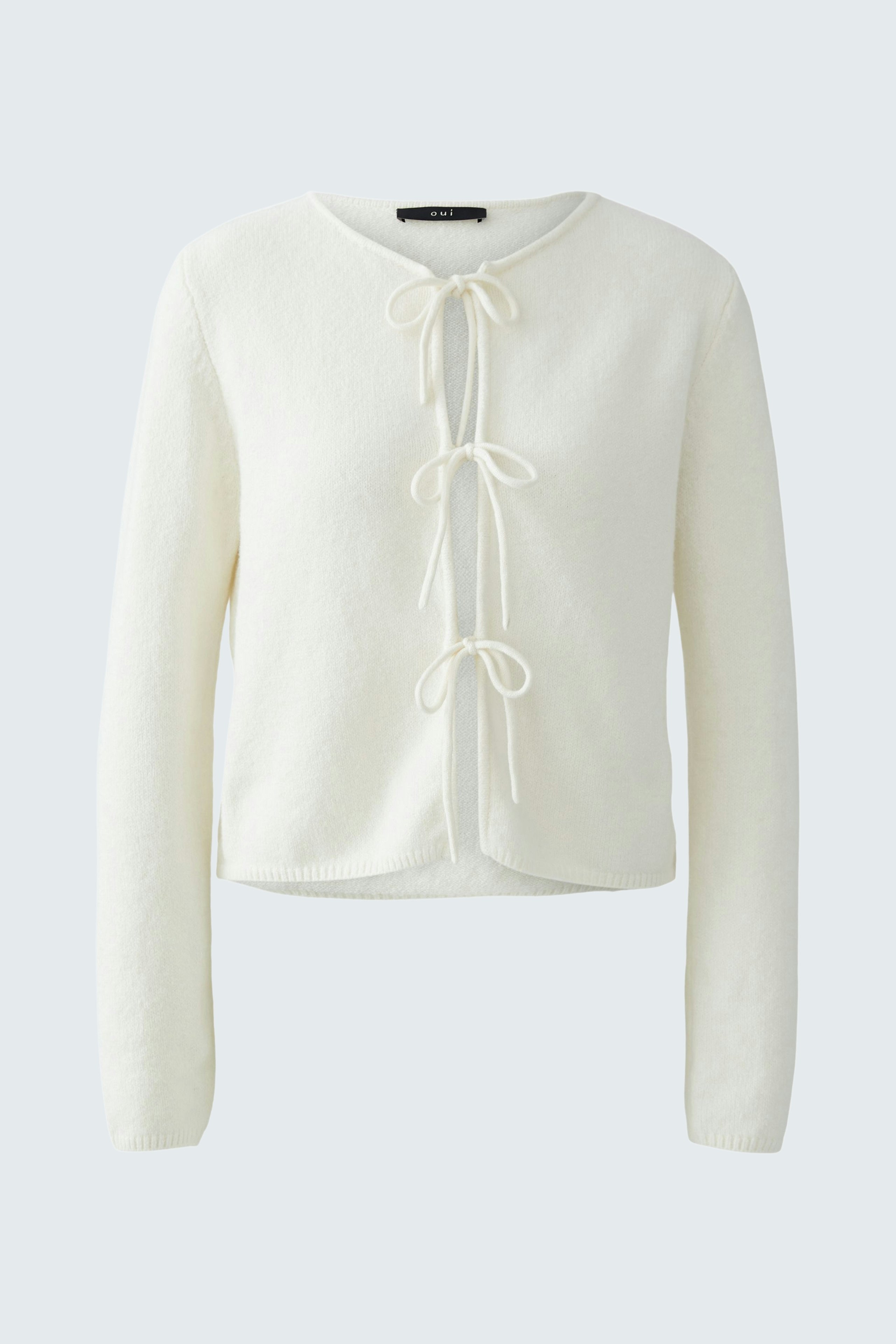 Casual women's cardigan: A white knitted cardigan with ties at the front, perfect for layering.