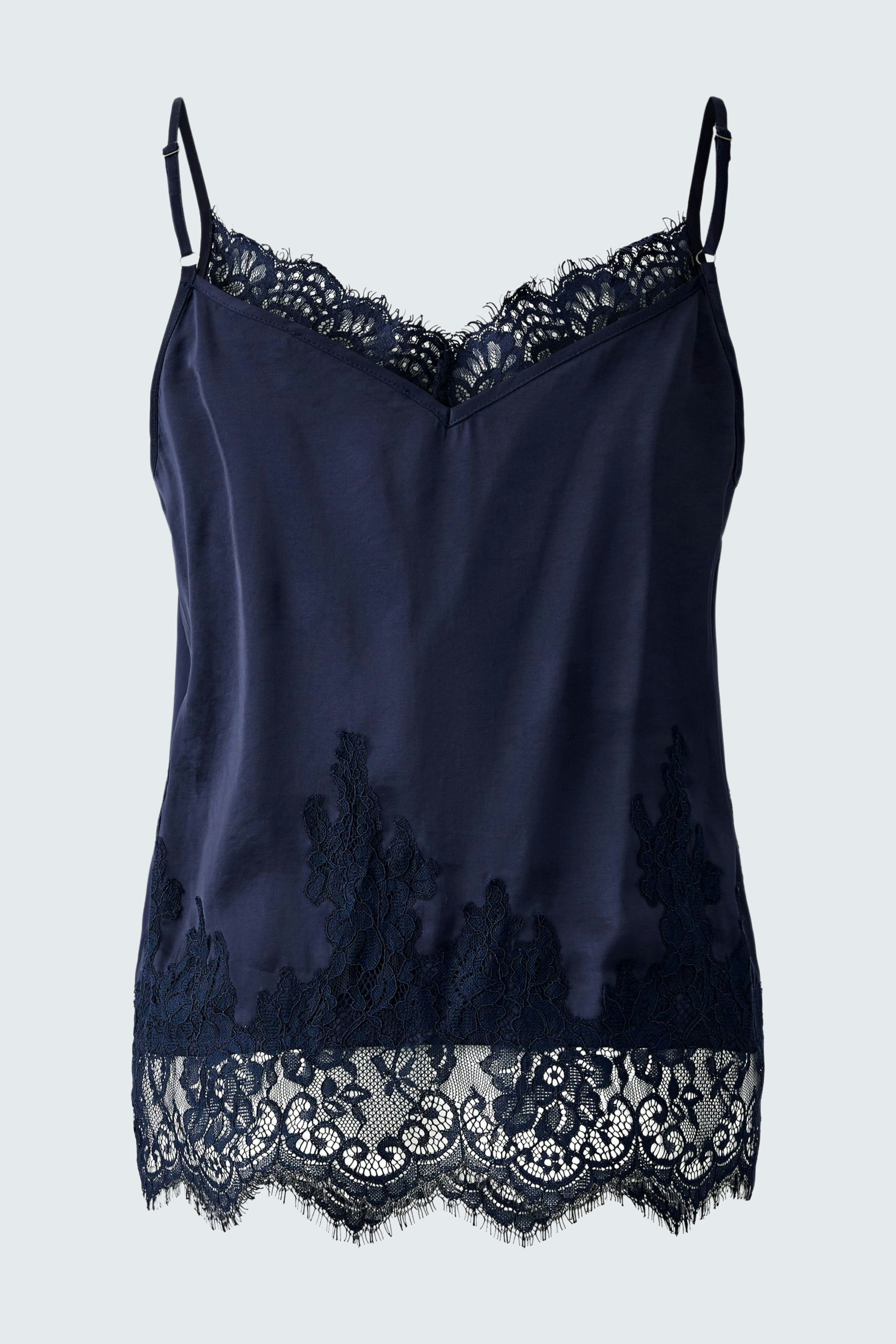 Casual women's top: A woman in a navy camisole with lace detailing, perfect for layering.