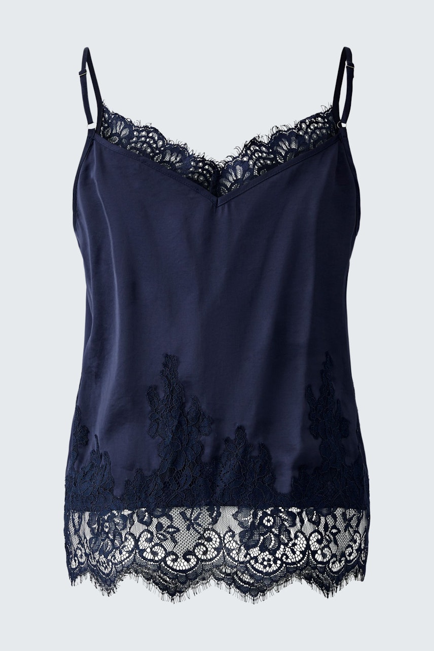 Casual women's top: A woman in a navy camisole with lace detailing, perfect for layering.