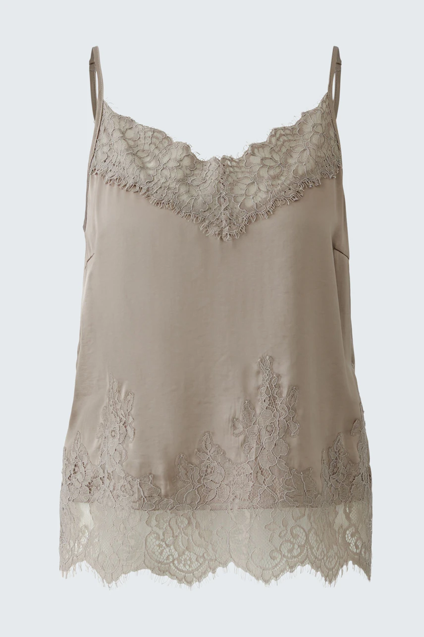 Light beige top with lace details, featuring thin straps and a relaxed fit.
