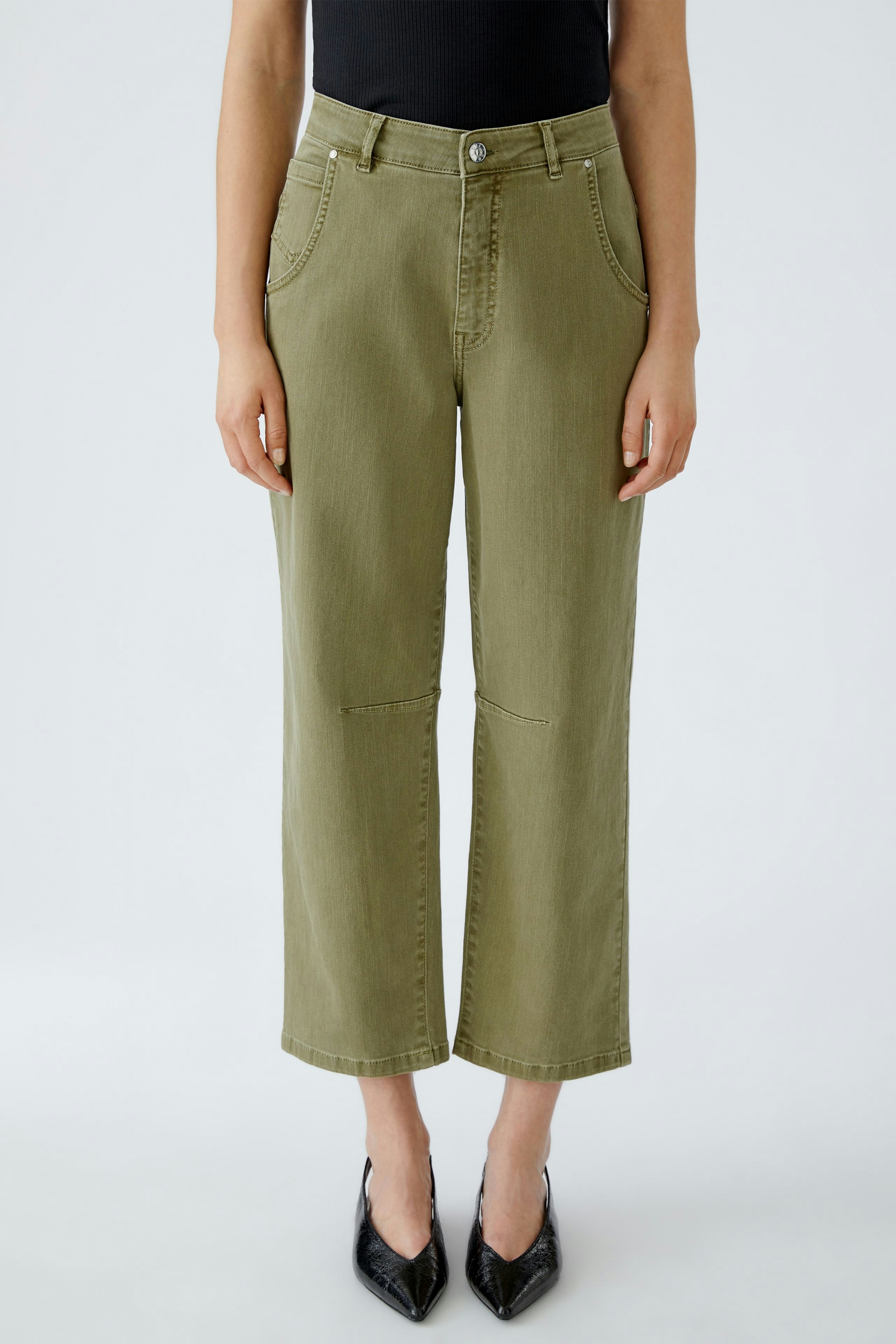 Casual women's jeans: A woman in olive green barrel jeans with a relaxed fit and classic design.