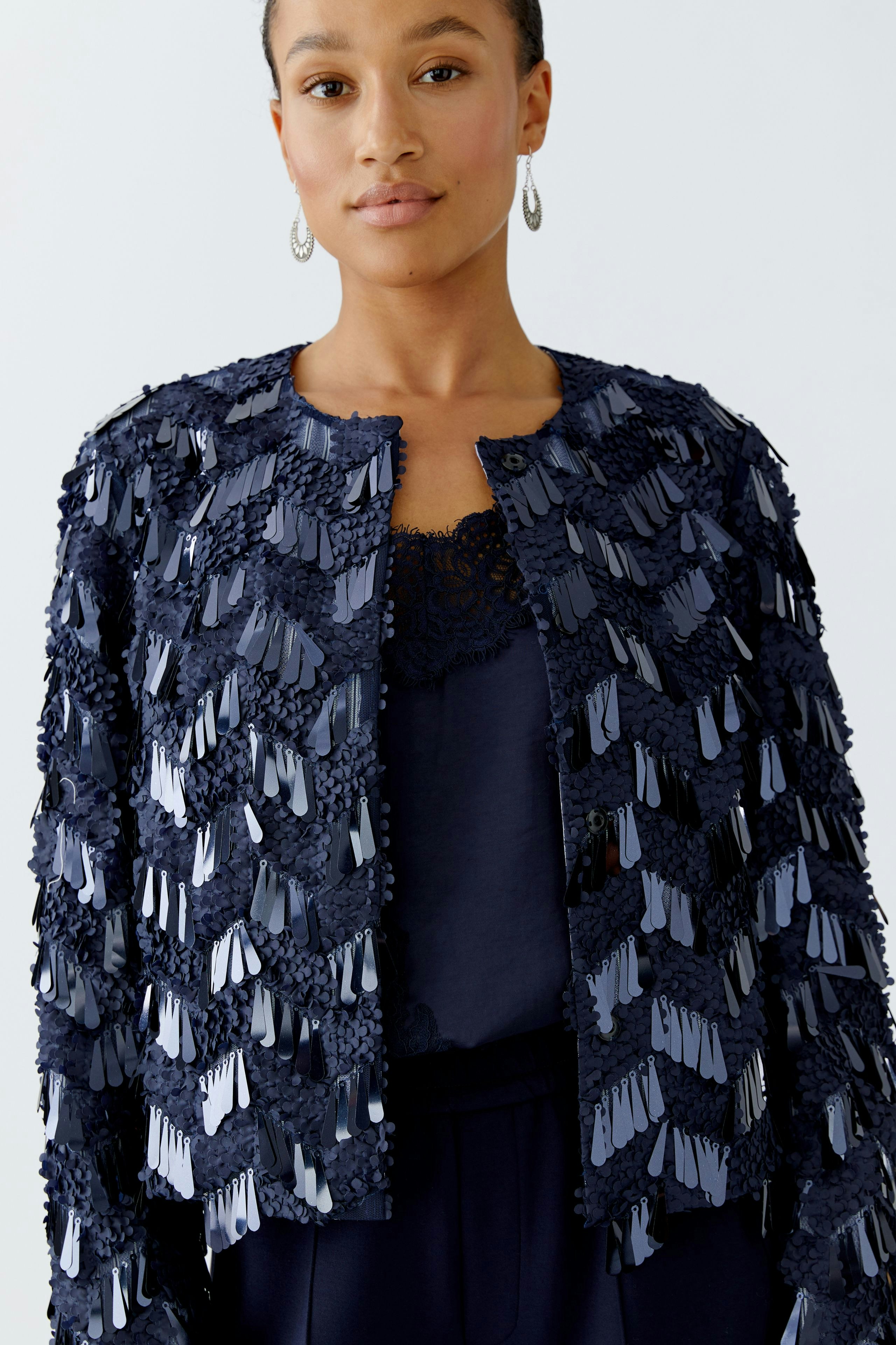 Stylish women's jacket: A woman in a navy jacket with textured detailing, perfect for casual outings.