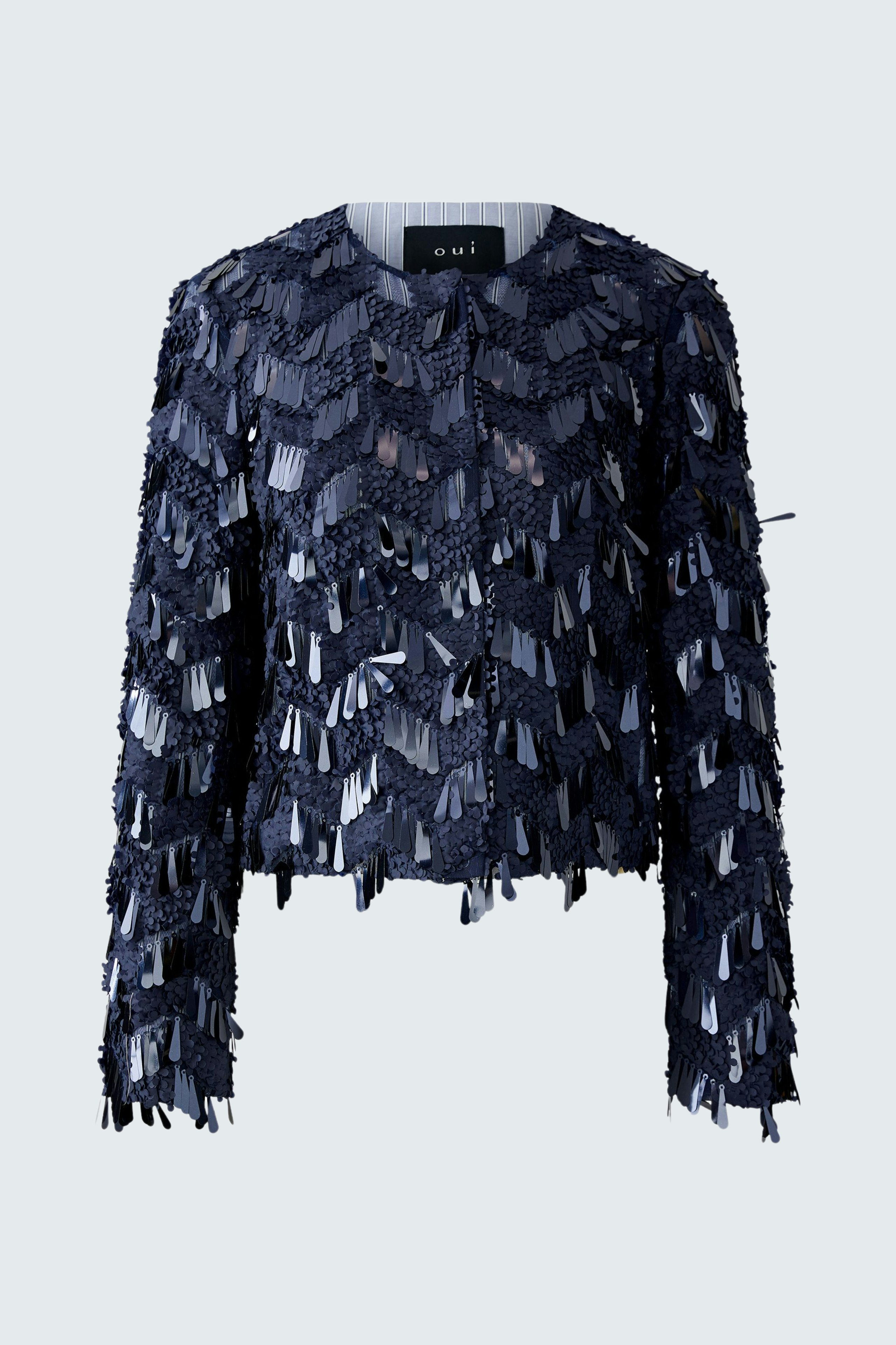 Stylish women's jacket: A woman in a navy jacket with fringes, perfect for casual outings.