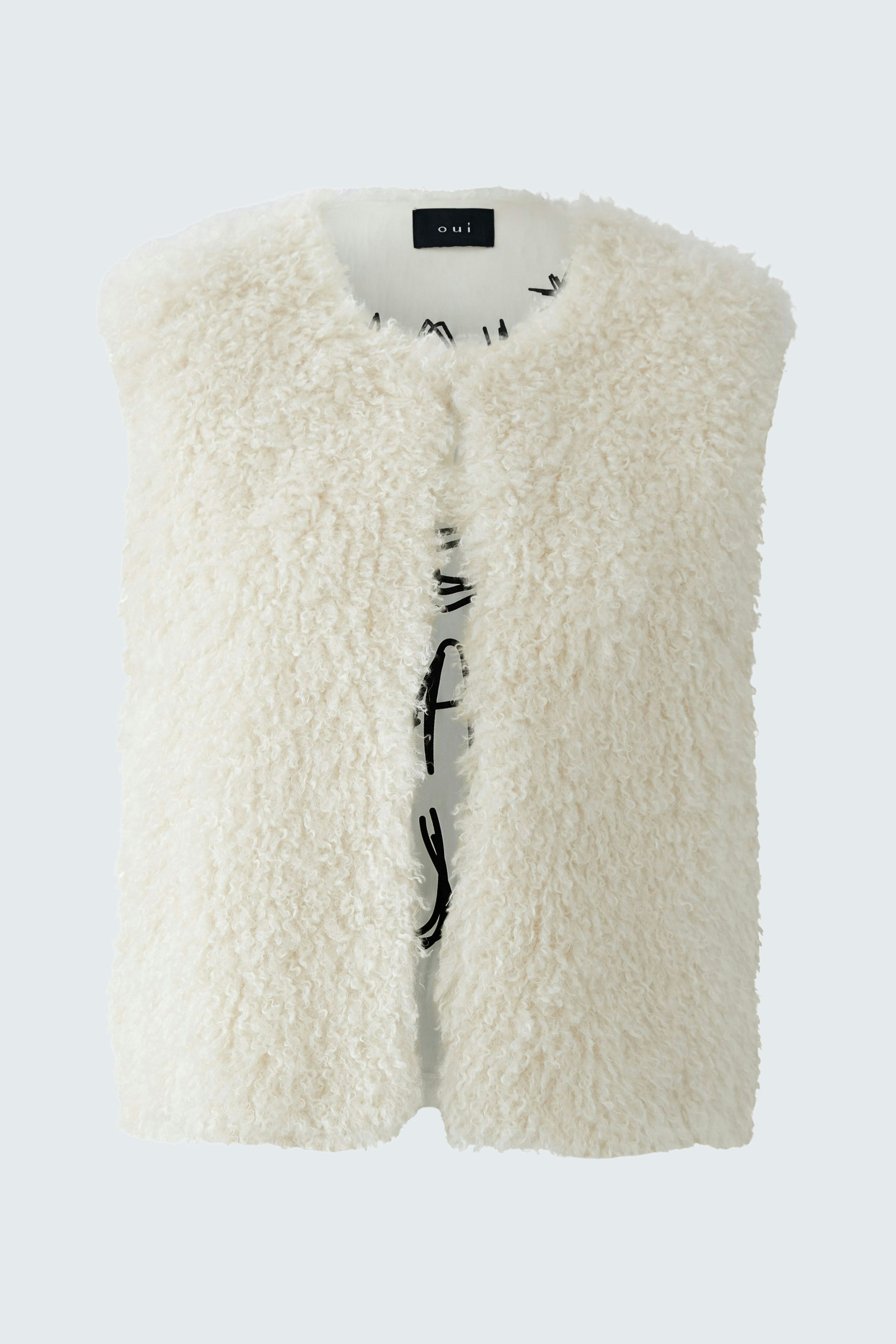 Cozy women's vest in soft white faux fur, perfect for layering over casual outfits.
