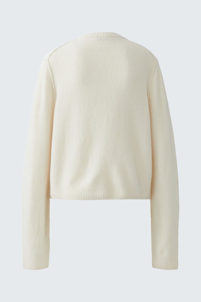 Casual women's cardigan in soft cream color, featuring a relaxed fit and long sleeves.