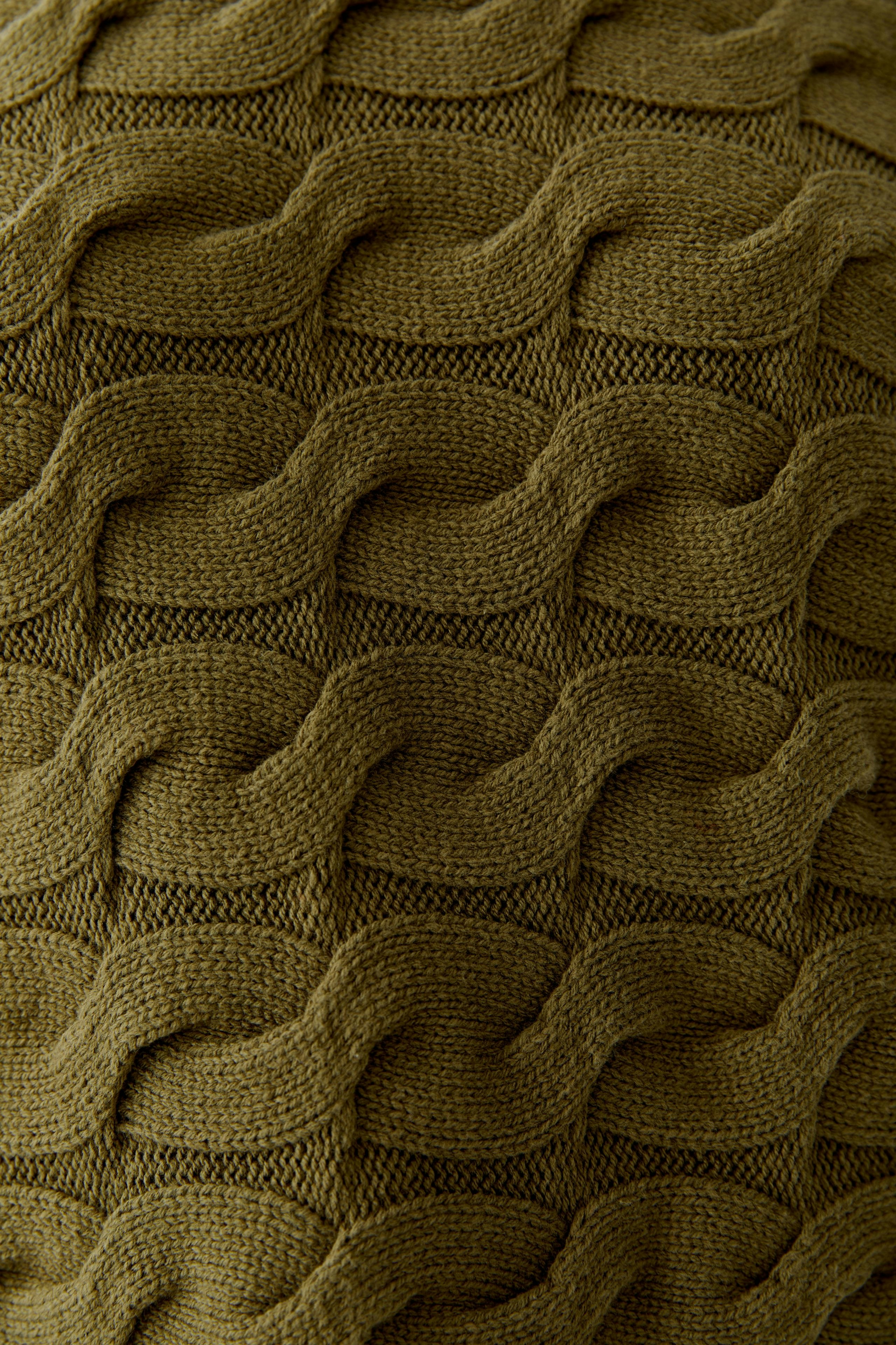 Textured green pullover showcasing a unique wave pattern, perfect for casual wear.