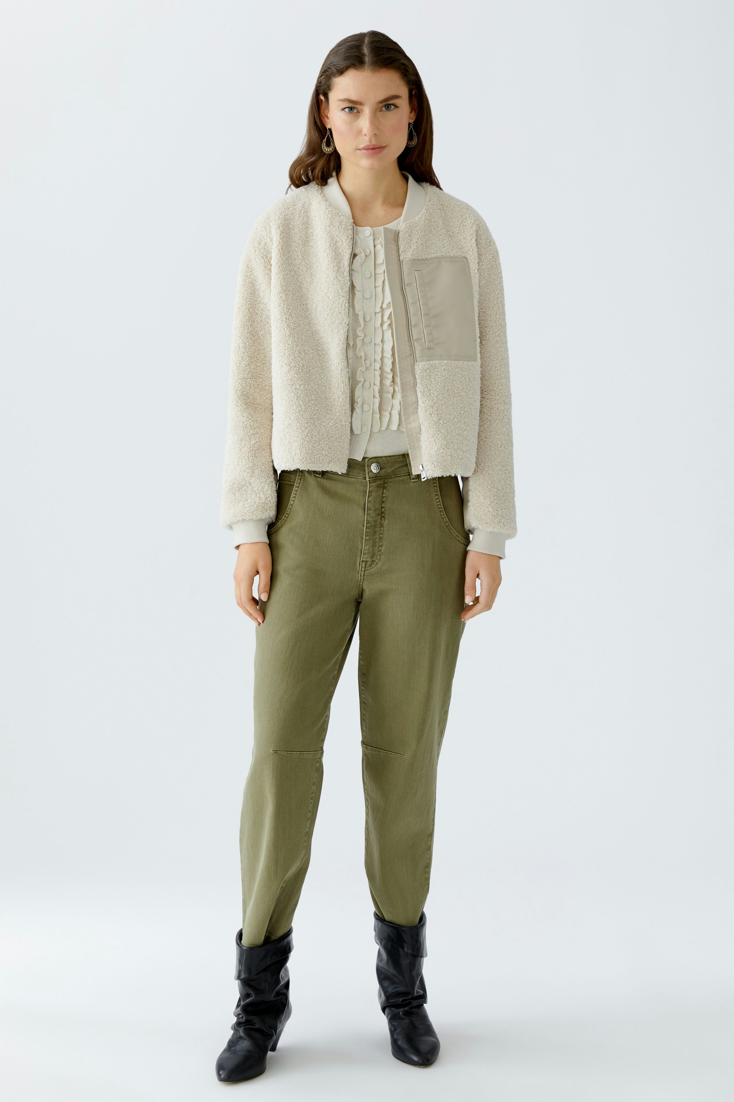 Casual women's blouson: A woman in a cozy cream bomber jacket with a textured finish.