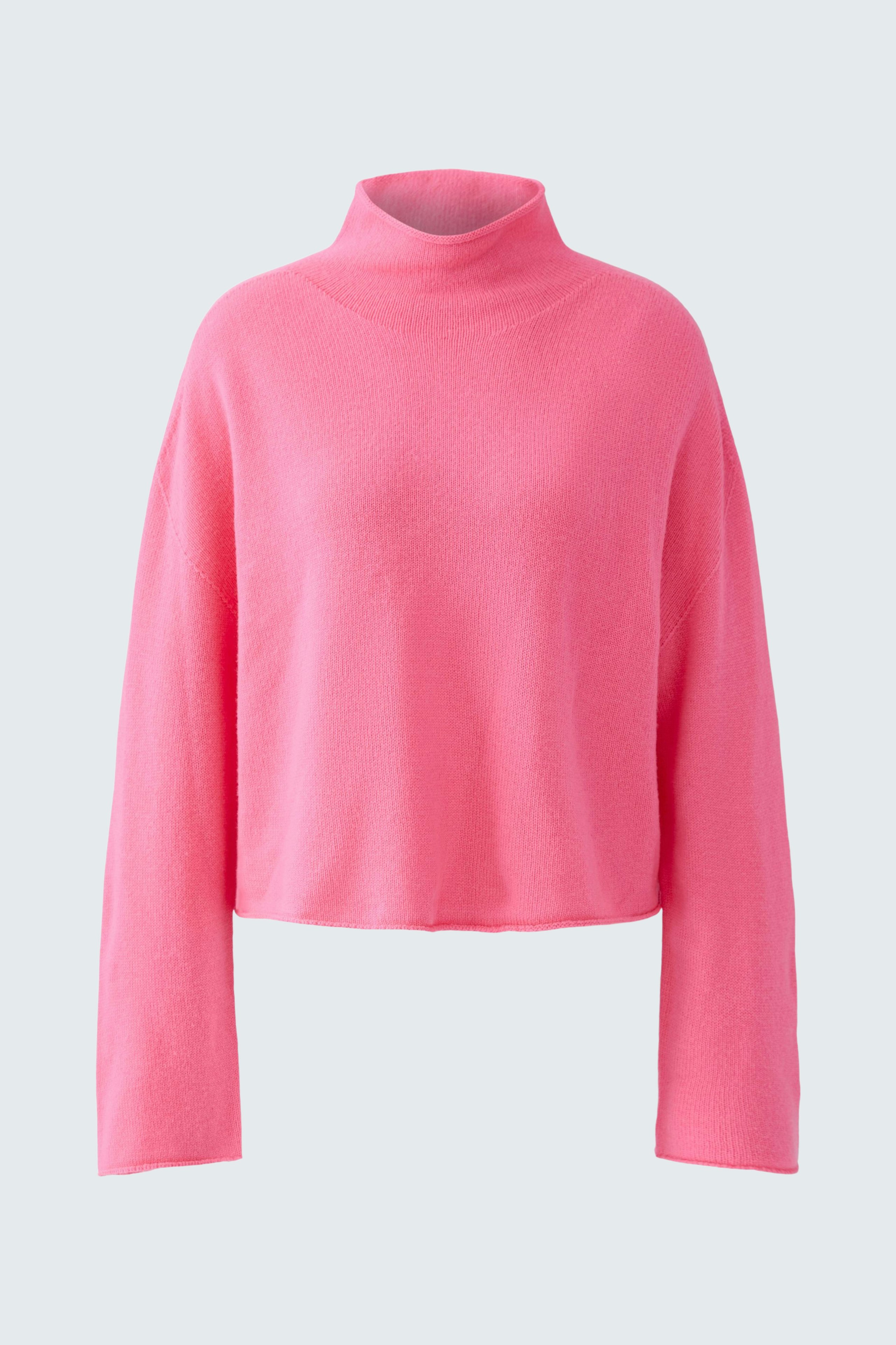 Casual women's pullover: A woman in a pink turtleneck pullover with long sleeves.