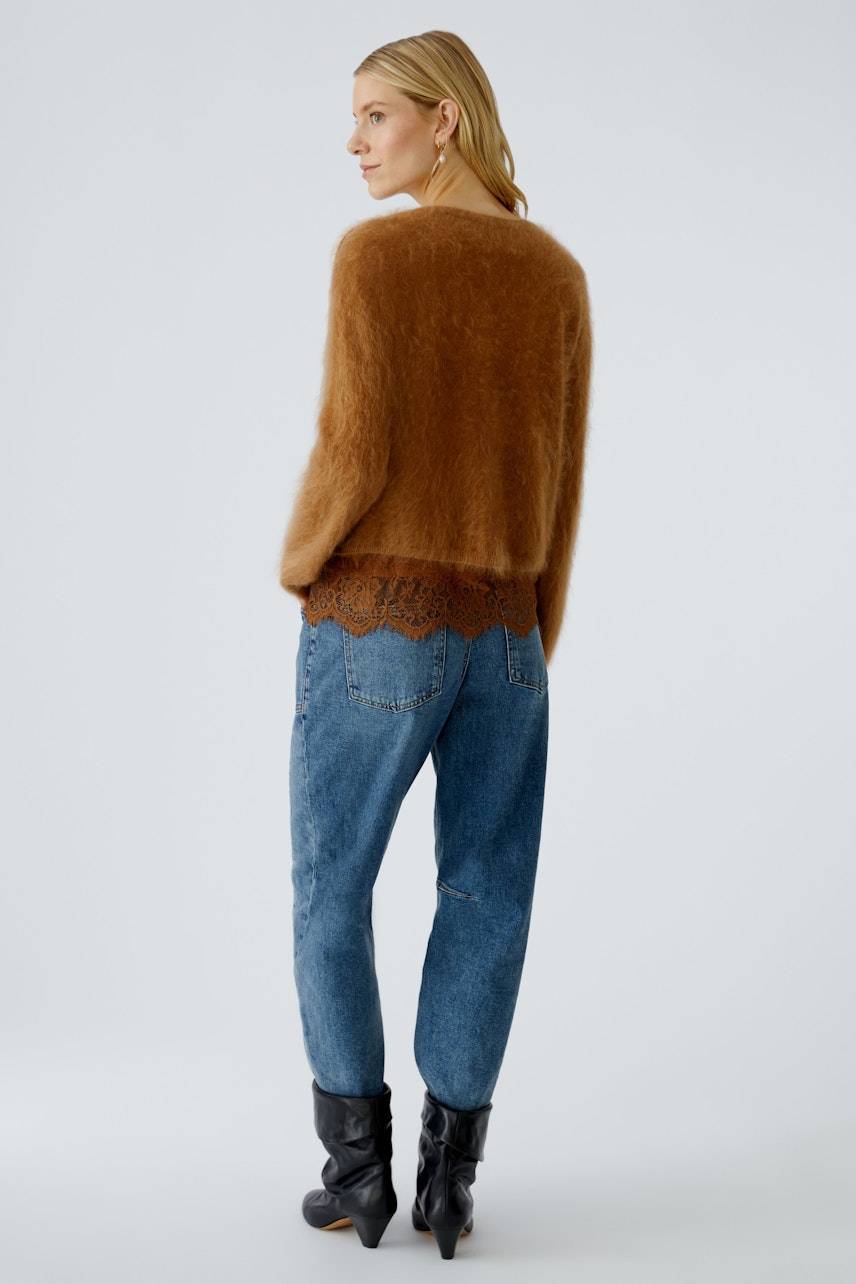 Cozy women's pullover in soft brown, paired with blue jeans, showcasing a relaxed fit.