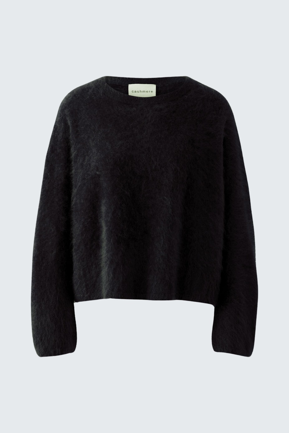 Casual women's pullover in soft black fabric, featuring a relaxed fit and long sleeves.