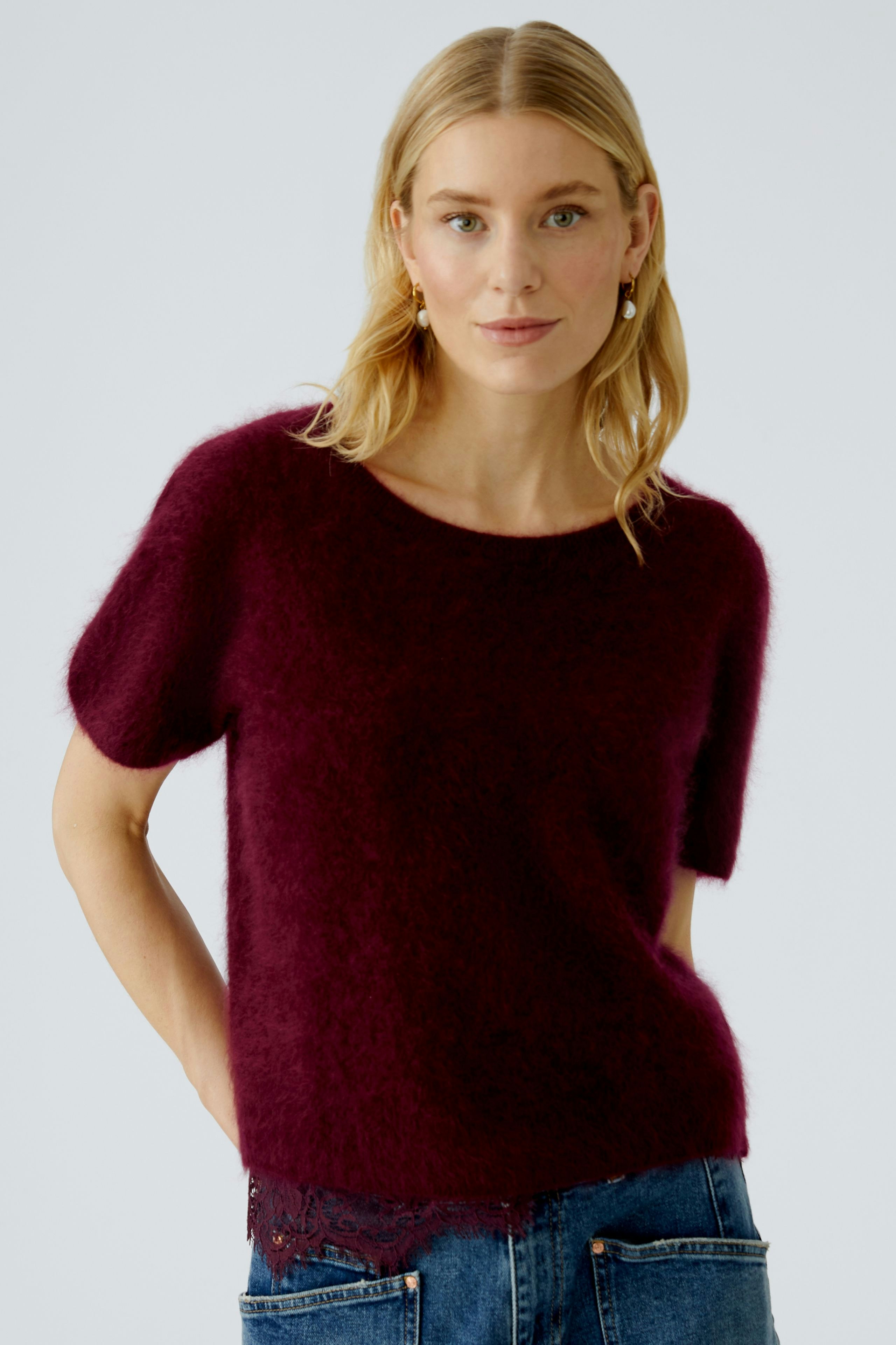 Casual women's pullover: A woman in a burgundy short-sleeve pullover with a soft texture and lace detail.