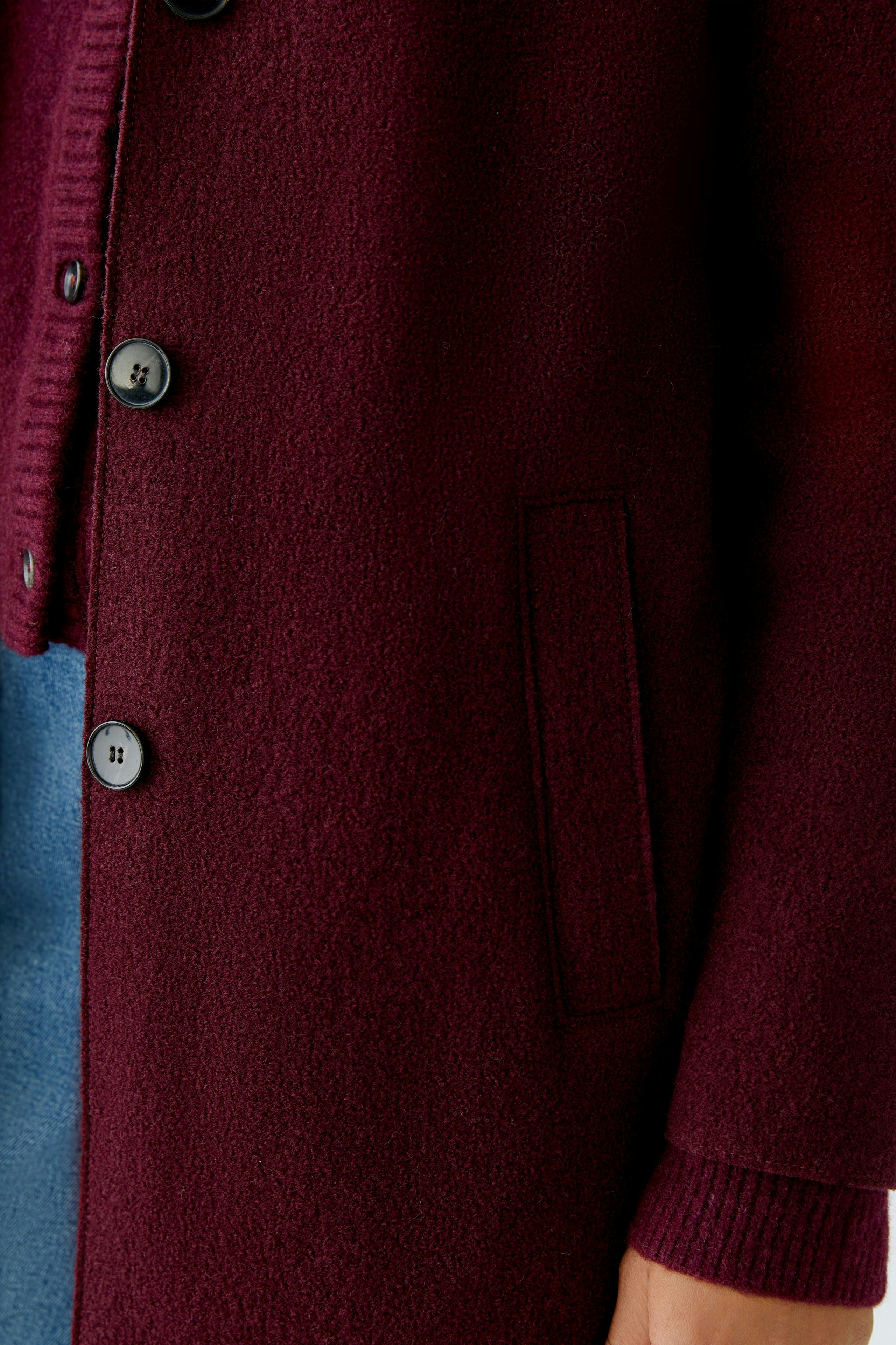 Cozy women's wool coat in deep burgundy with buttons and side pockets, perfect for casual wear.