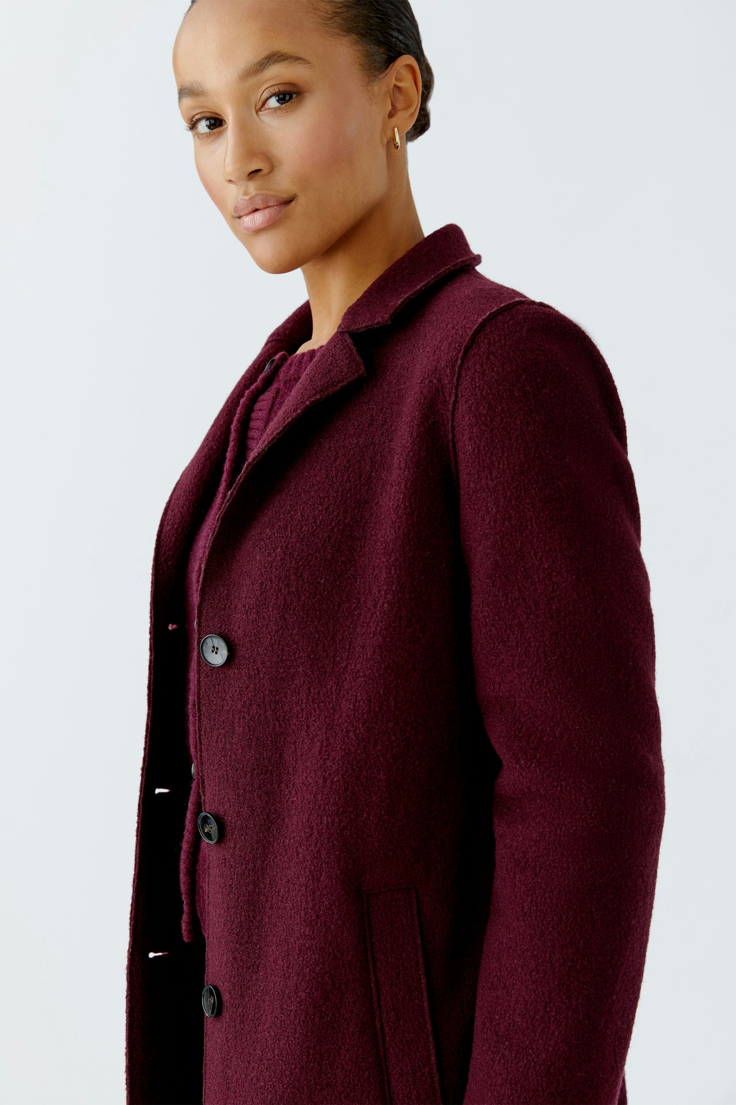 Stylish women's wool coat in deep burgundy, featuring a classic collar and button closure.