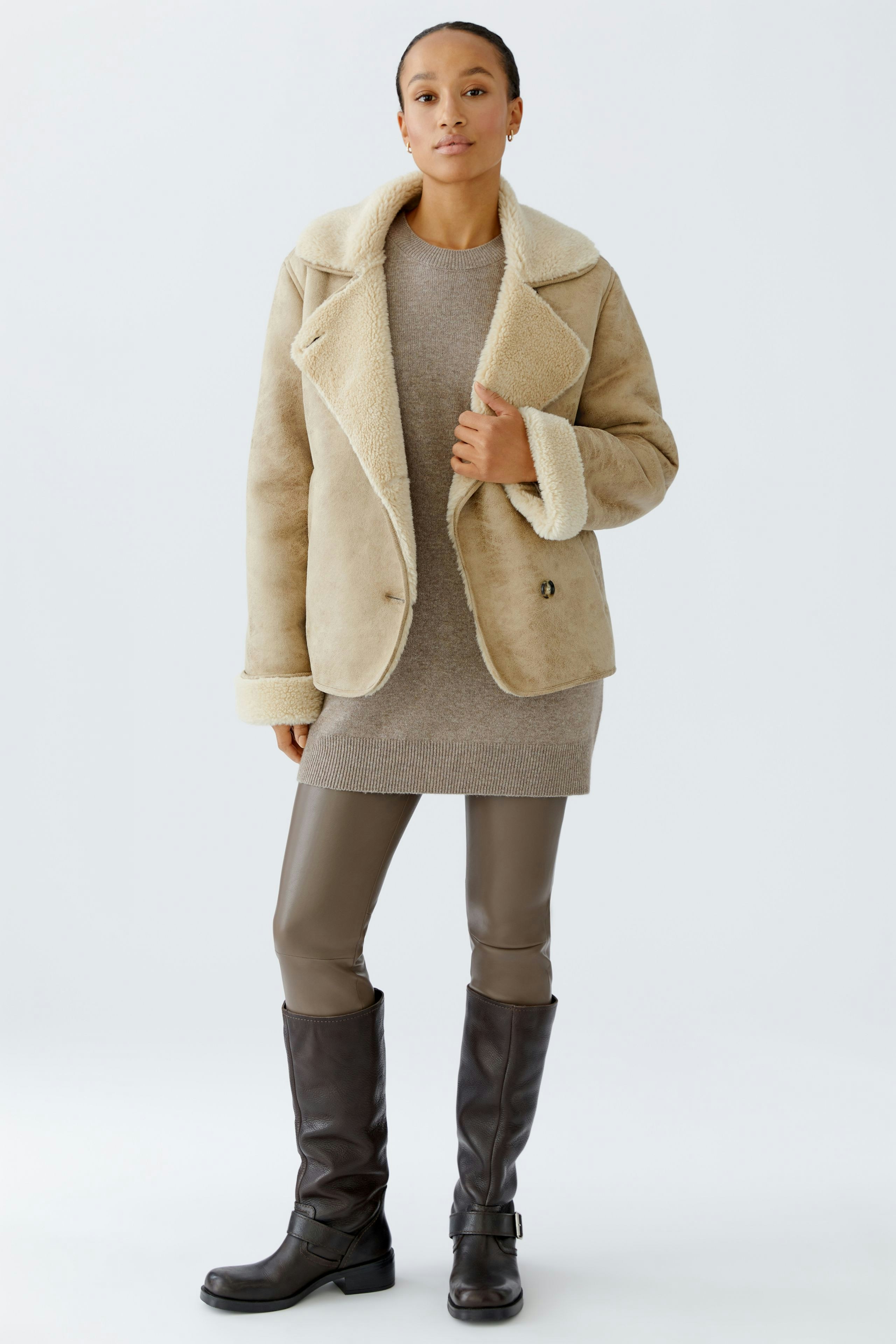 Comfortable leggings worn by a woman, paired with a cozy jacket and stylish boots.