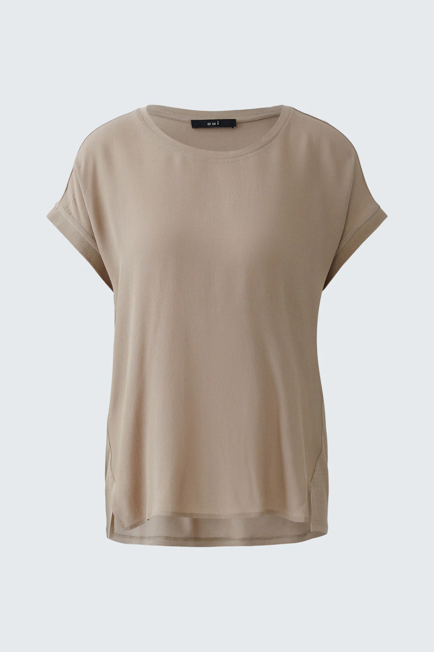 Casual women's blouse shirt in soft beige with short sleeves and a relaxed fit.