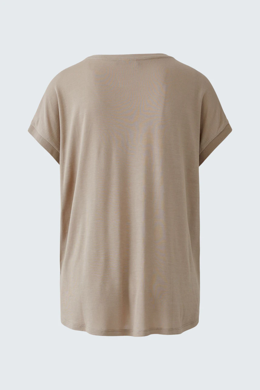 Casual women's blouse shirt in soft beige, featuring a relaxed fit and short sleeves.