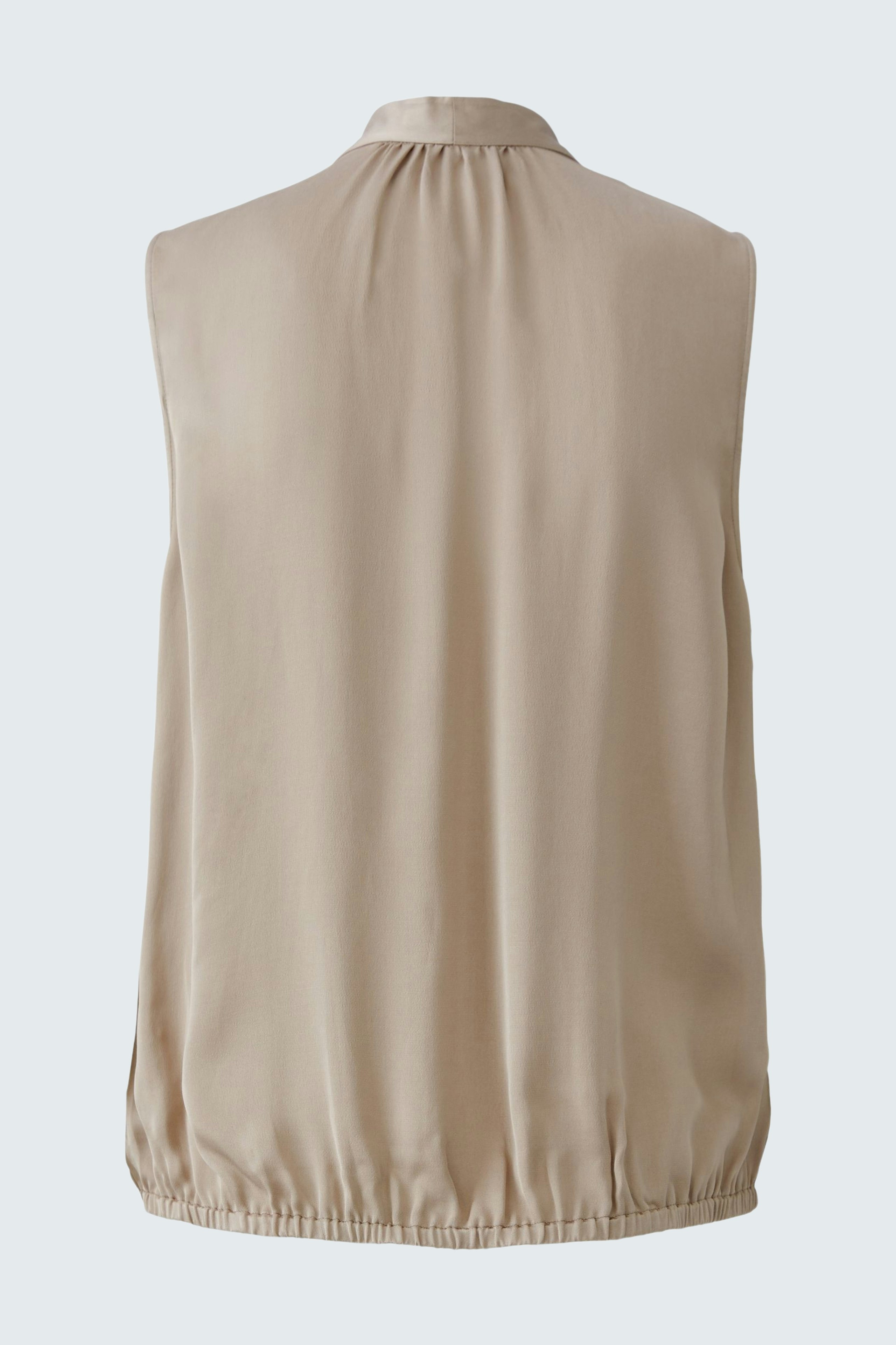 Lightweight sleeveless blouse: A woman in a beige blouse with a gathered neckline and elastic hem.