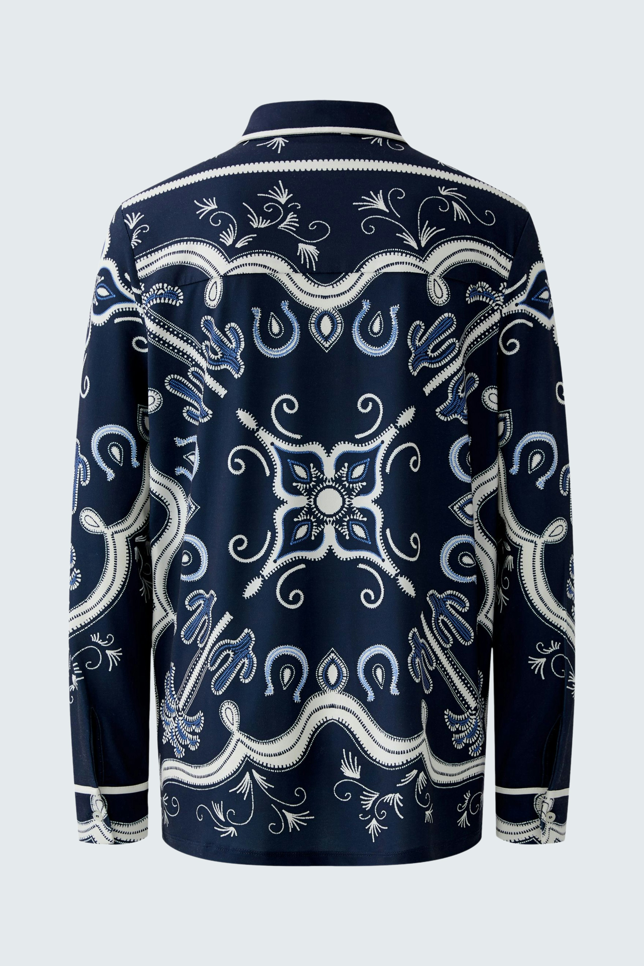 Stylish women's blouse: A woman in a navy patterned blouse with intricate designs, showcasing a relaxed fit.
