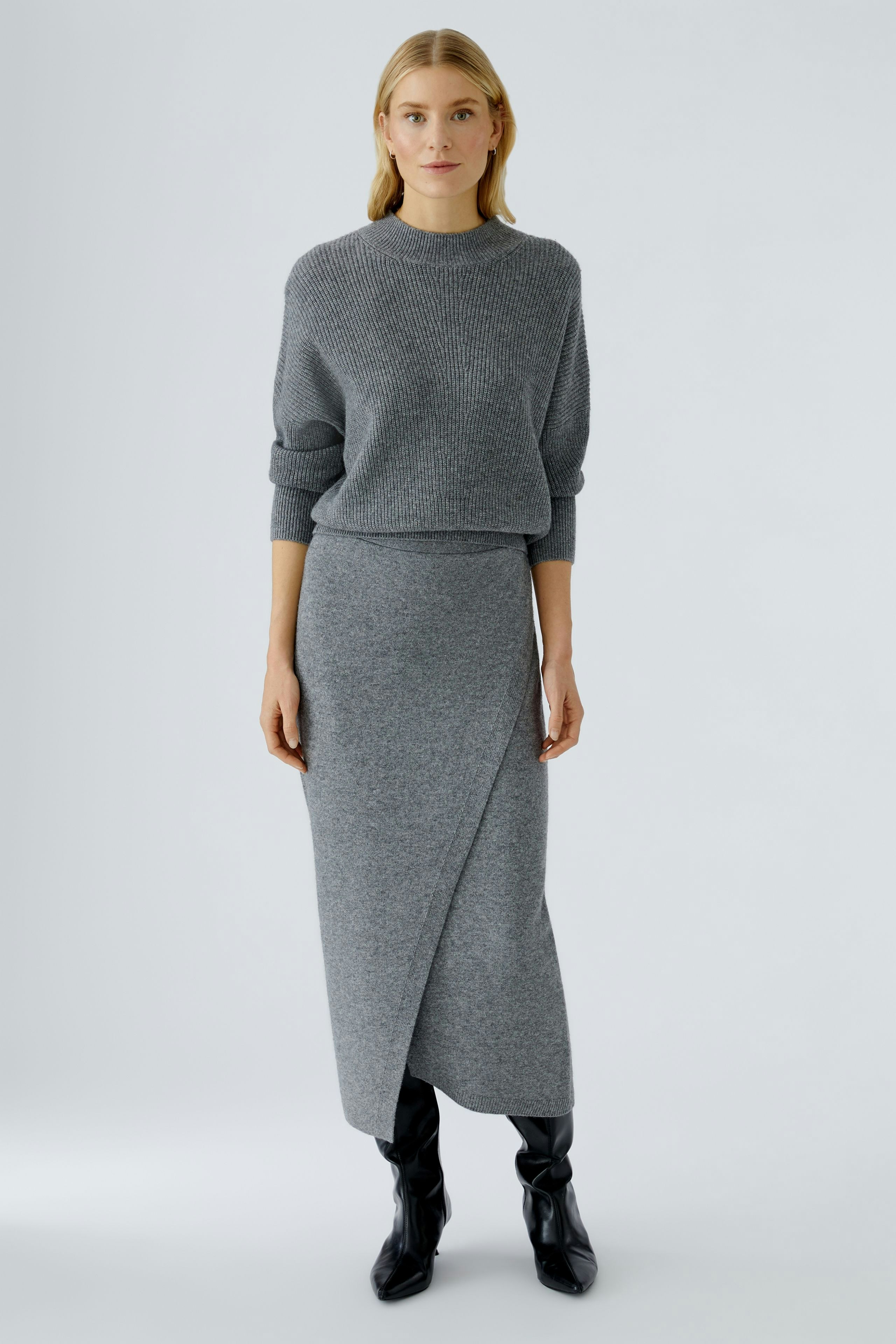 Casual women's knit skirt: A woman in a gray knit skirt paired with a matching pullover.