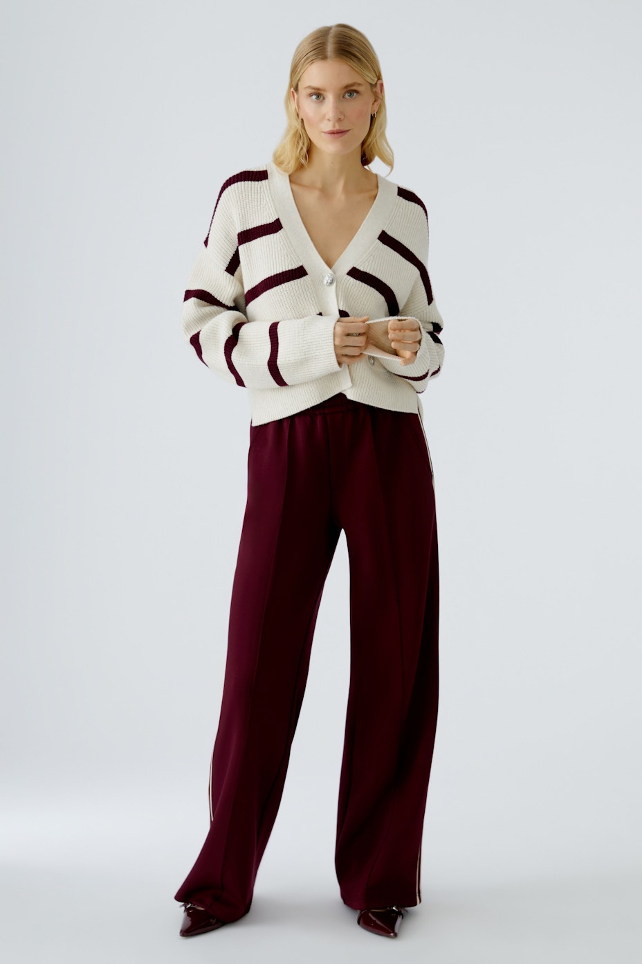 Casual women's cardigan: A cropped, striped pullover in cream and burgundy, perfect for layering.