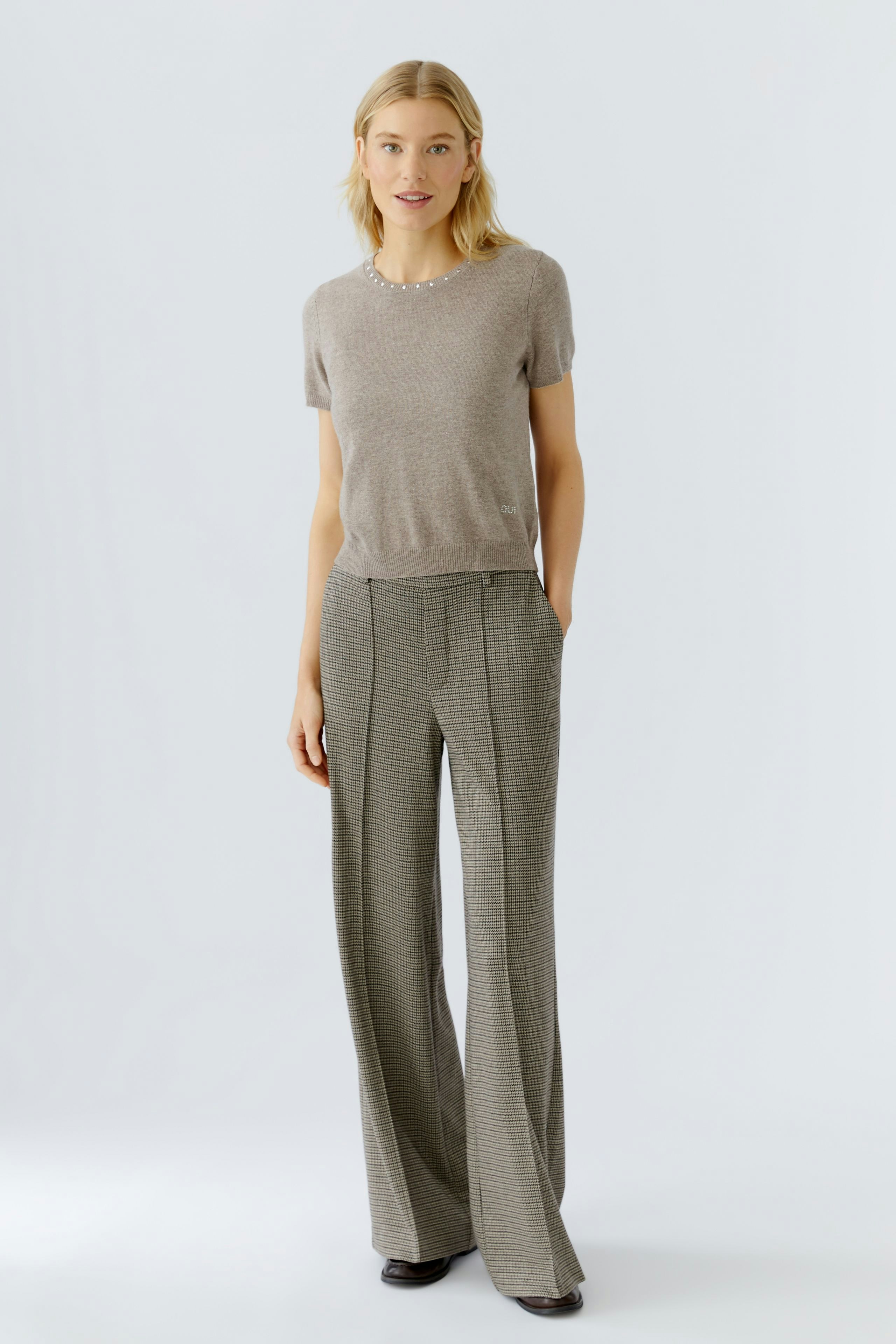 Casual women's trousers: A woman in striped wide-leg pants with a relaxed fit.
