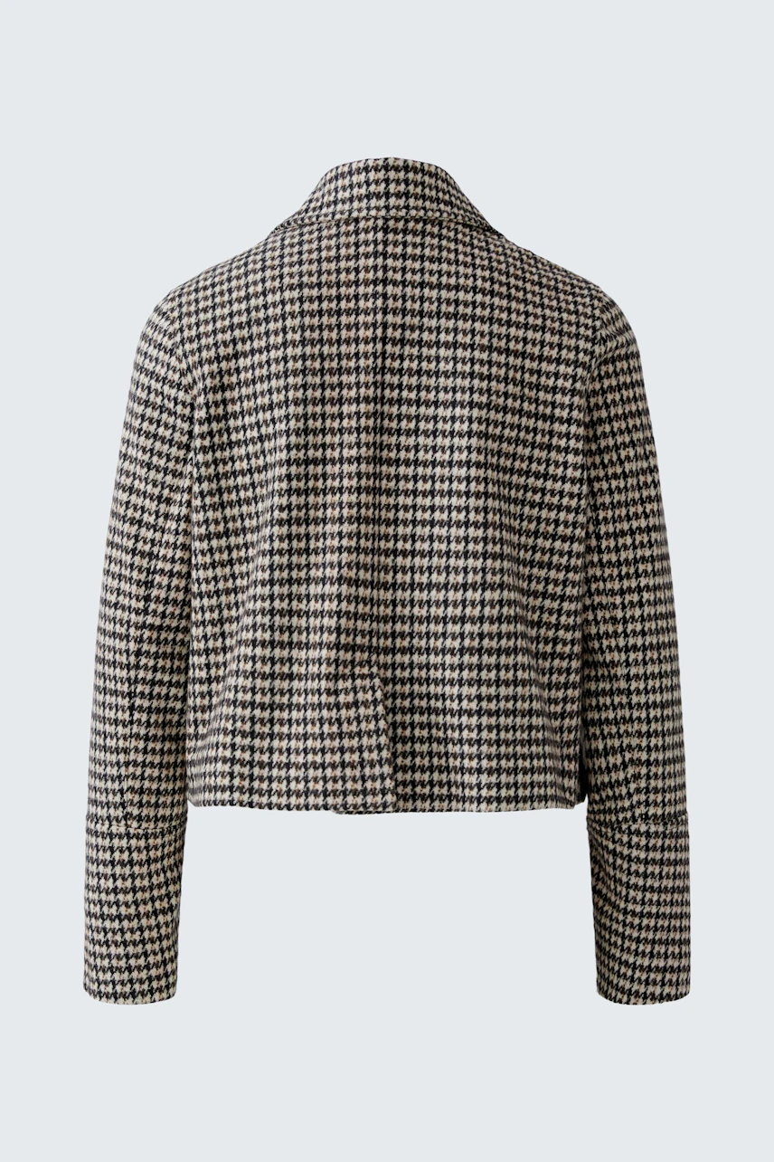 Stylish women's jacket: A woman in a checkered cropped jacket with a relaxed fit.