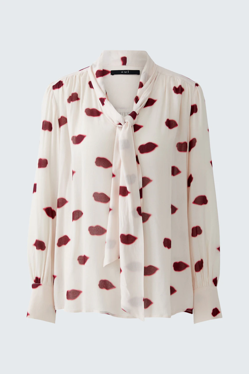 Lightweight women's blouse with a playful lip print and a tie detail at the neckline.