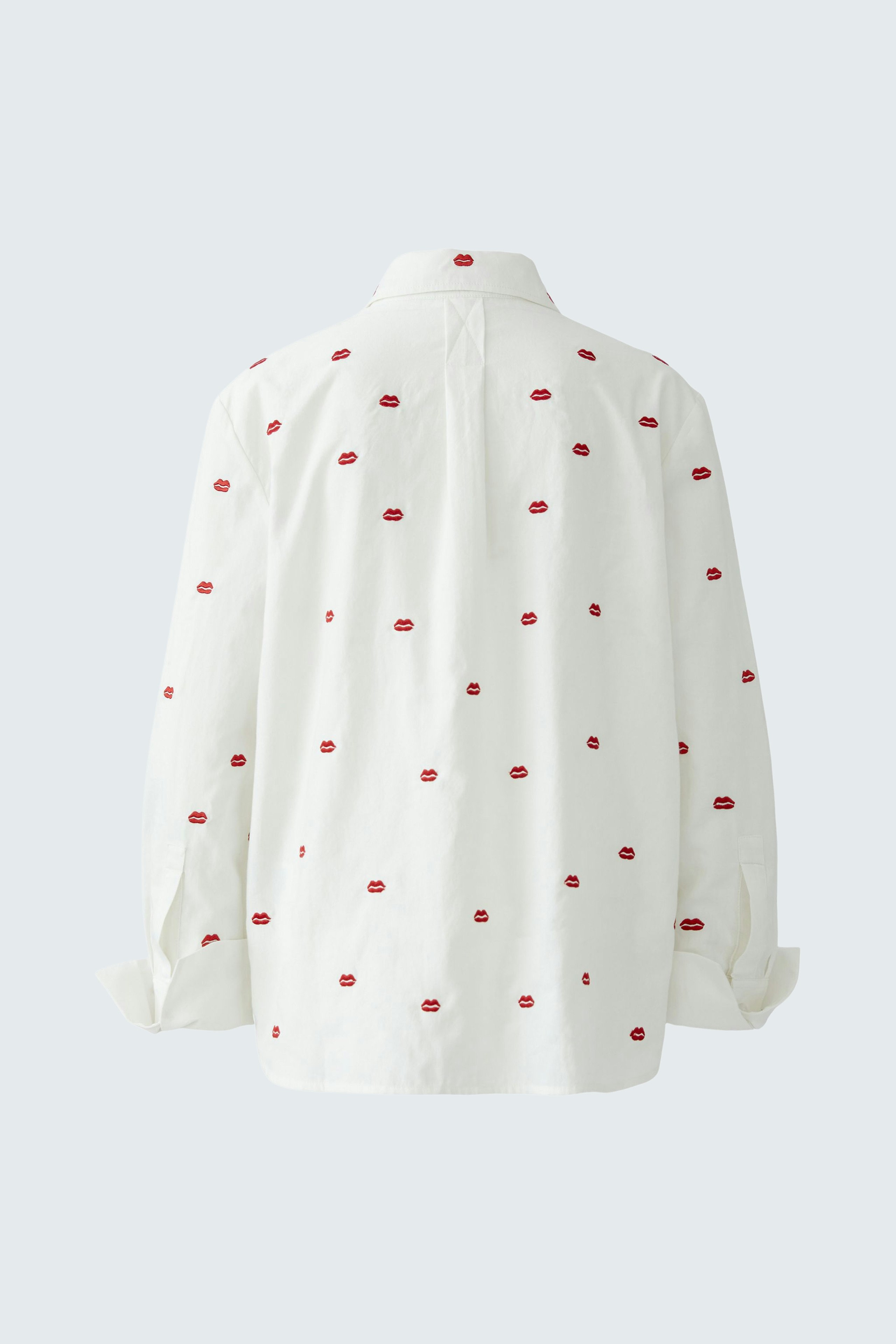Casual women's blouse: White shirt with red dots, featuring a relaxed fit and button-down collar.