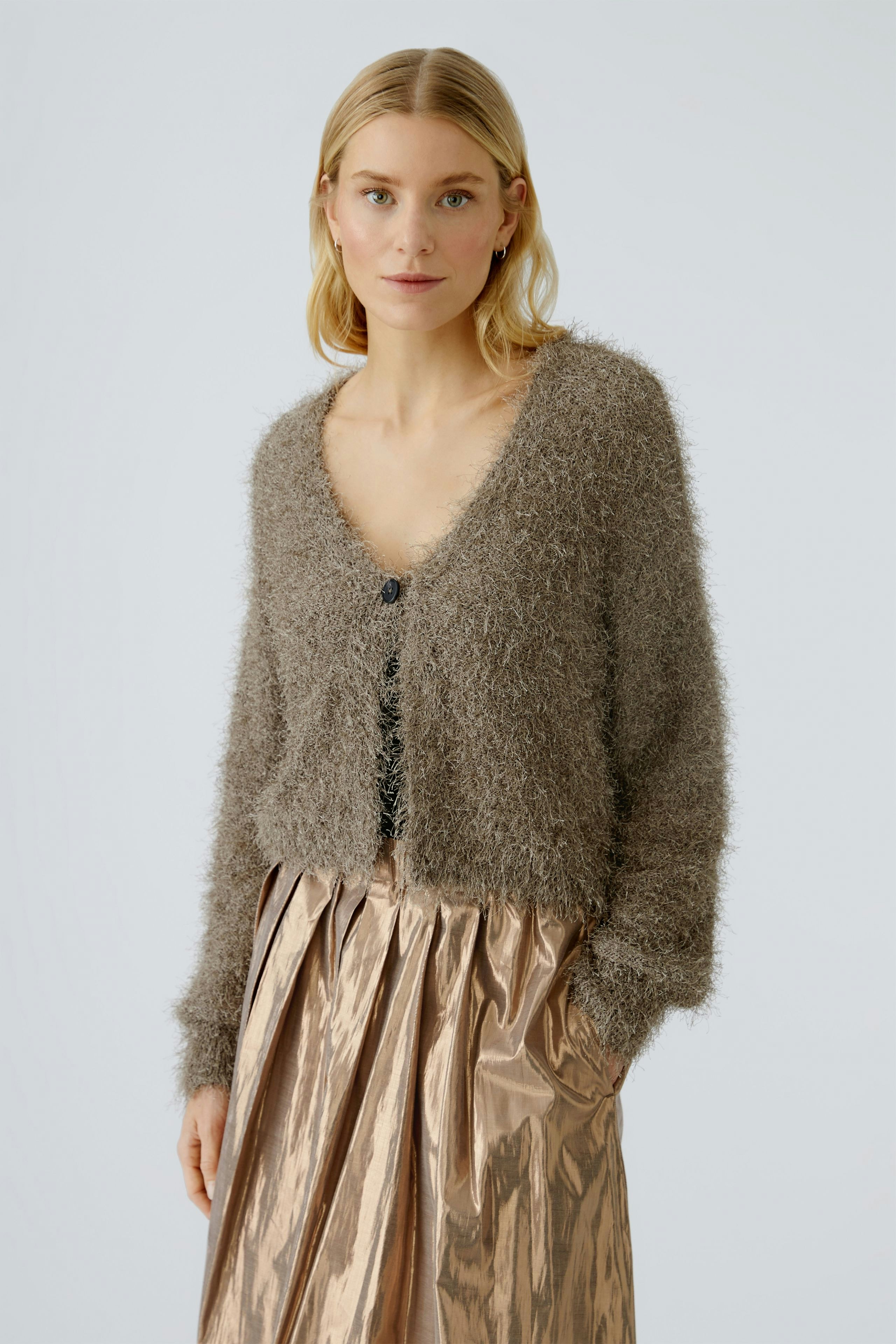 Cozy women's cardigan: A woman in a soft, fuzzy cardigan with a deep V-neck and button closure.
