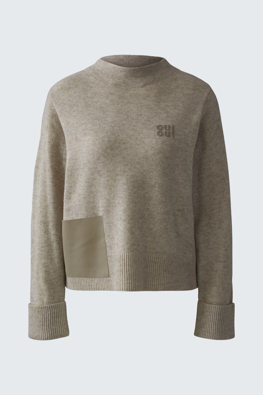 Casual women's pullover in light beige with a unique patch detail and relaxed fit.