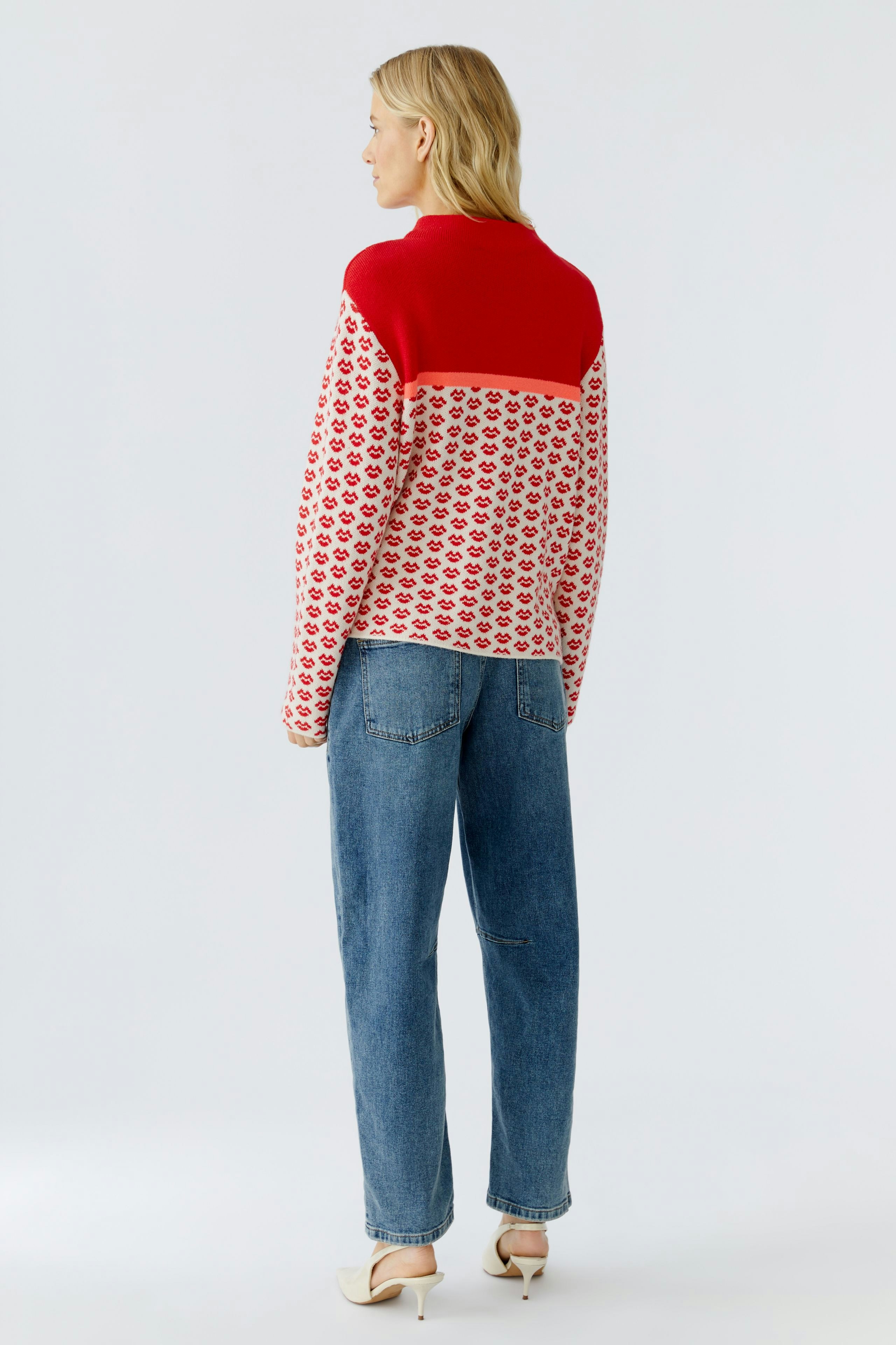 Casual women's pullover: A woman in a colorful patterned pullover with a red top and relaxed fit.