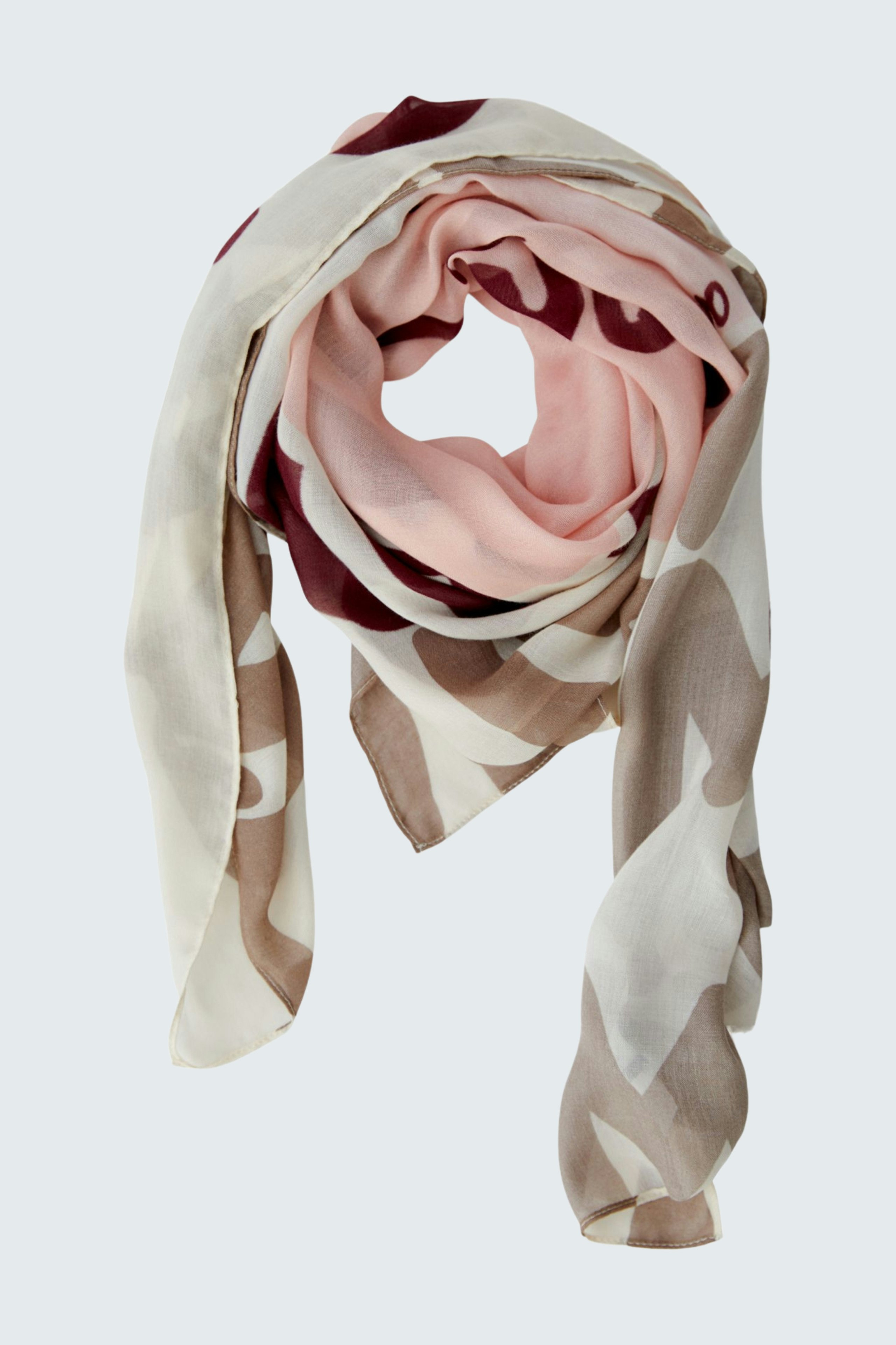 Stylish scarf: A woman wearing a soft, patterned scarf in pink and beige, adding a trendy touch.