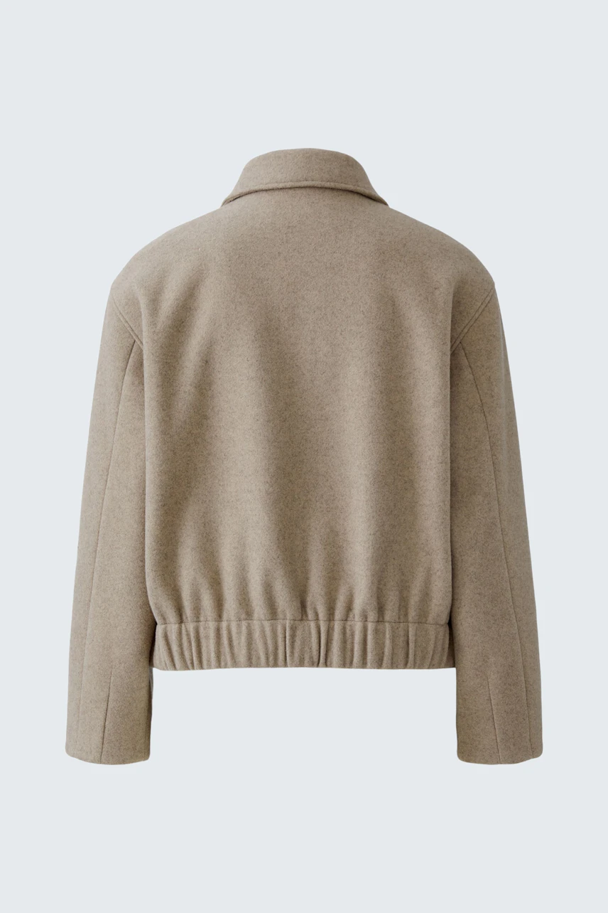 Casual women's jacket: Back view of a beige jacket with a relaxed fit and elastic hem.