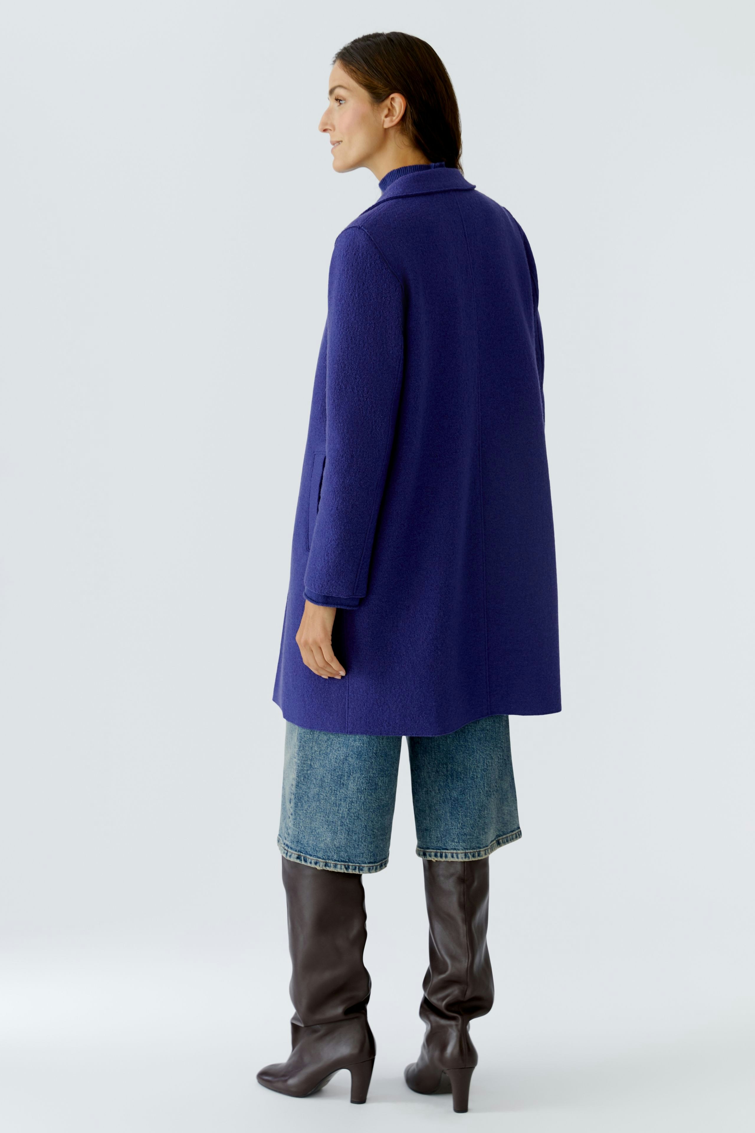Casual women's wool coat: A woman in a purple coat with a relaxed fit, paired with brown wide-leg pants.