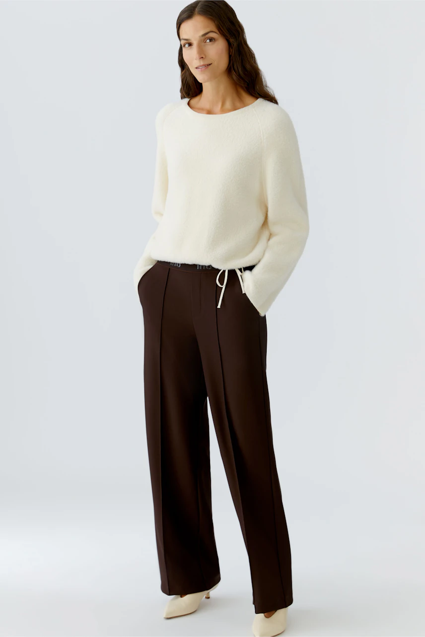 Comfortable women's trousers in dark brown with a relaxed fit and drawstring detail.