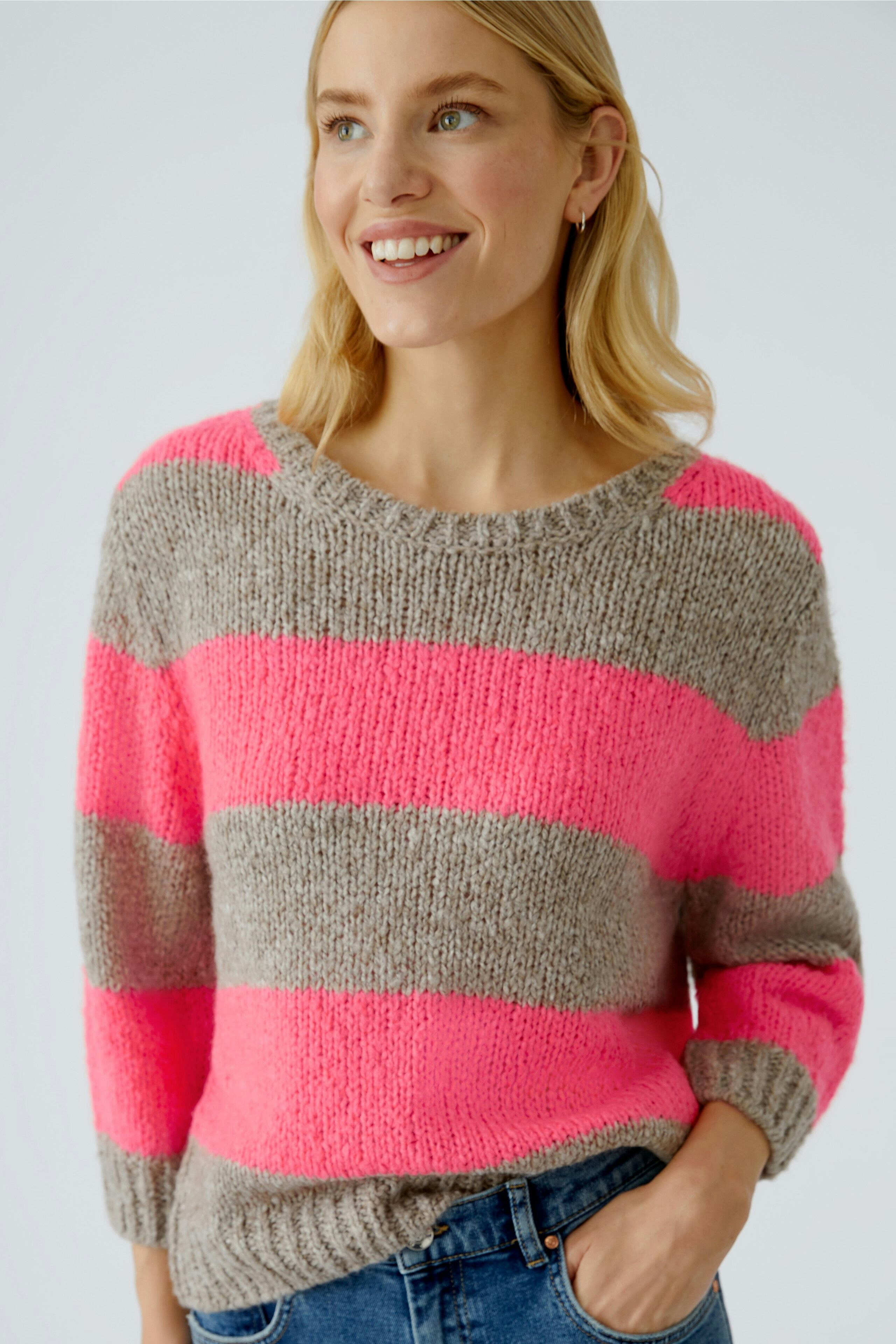 Casual women's pullover: Smiling woman in a striped pullover with pink and gray colors.