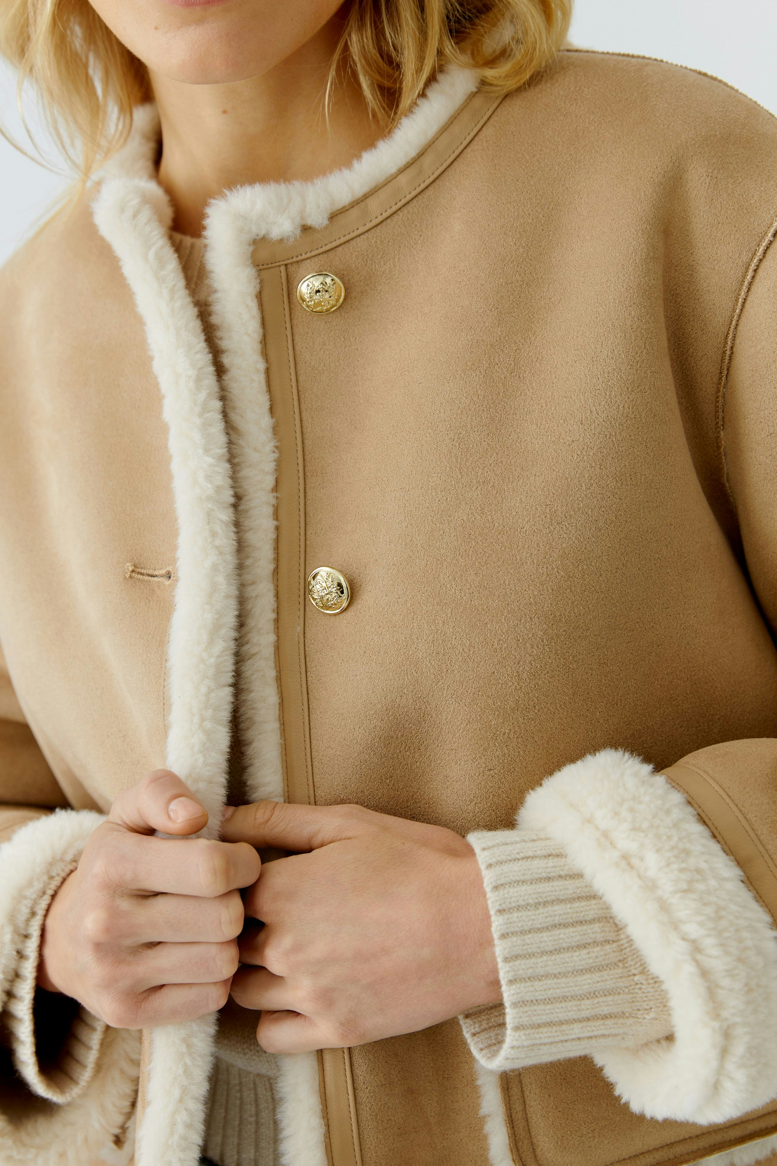 Stylish women's faux leather jacket with soft lining and gold buttons, perfect for casual wear.