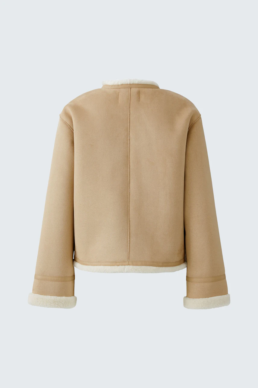 Stylish women's faux leather jacket in beige with a cozy lining, perfect for casual outfits.