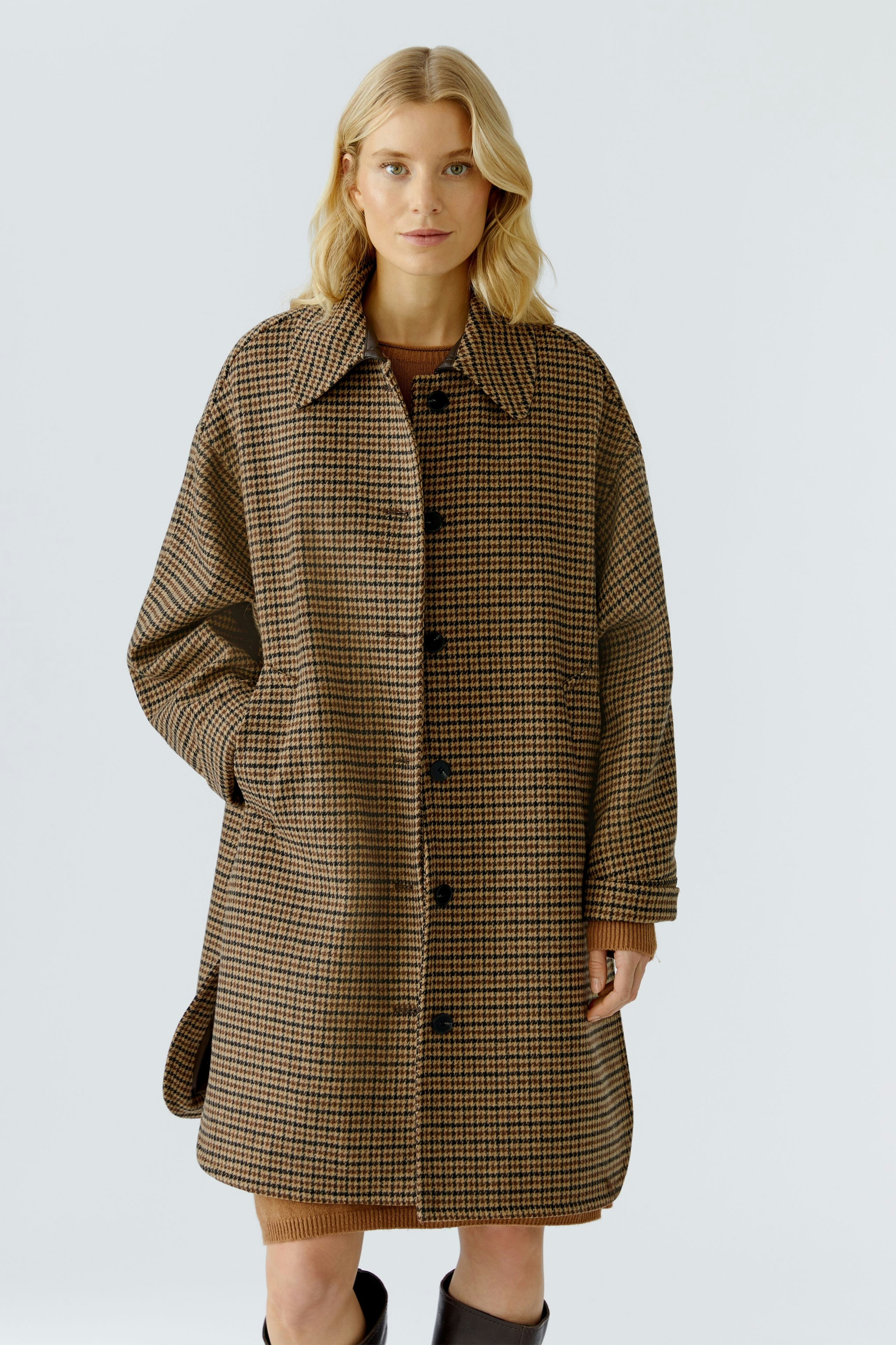 Casual women's wool coat: A woman in a brown checkered wool coat with a relaxed fit.