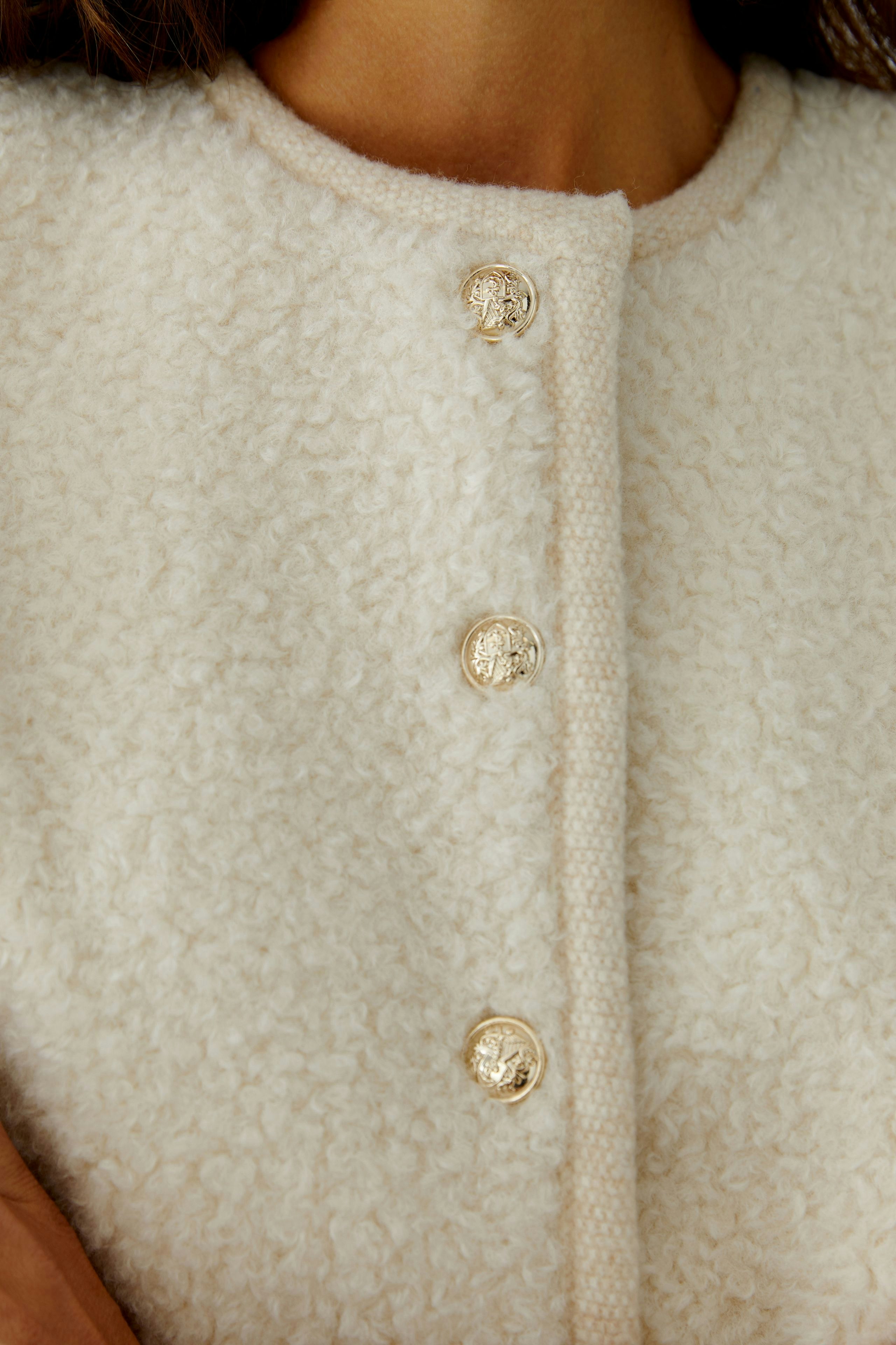 Cozy women's cardigan with textured fabric and stylish buttons, perfect for layering.