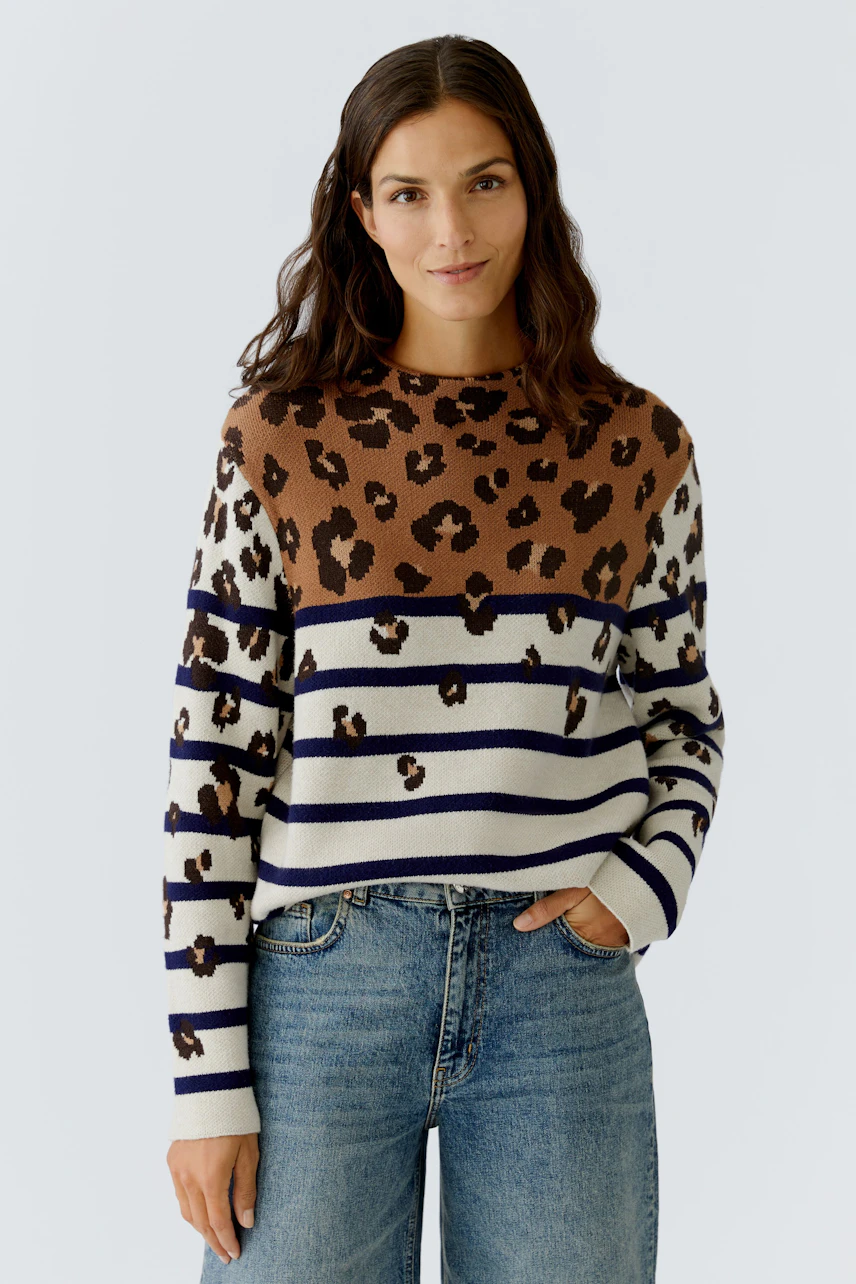 Casual women's pullover: A woman in a brown and striped pullover with a leopard print design.