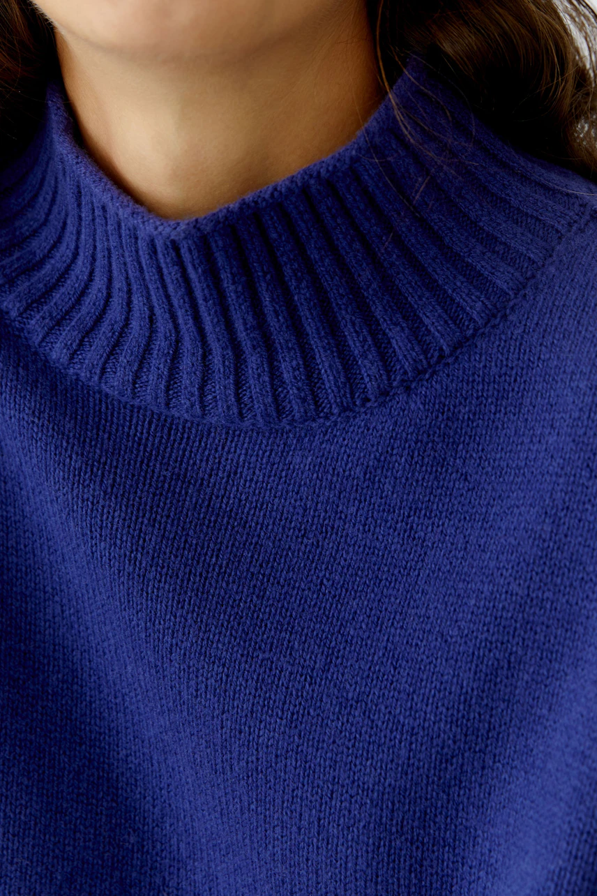 Cozy women's pullover with a high ribbed collar in deep blue, perfect for casual wear.