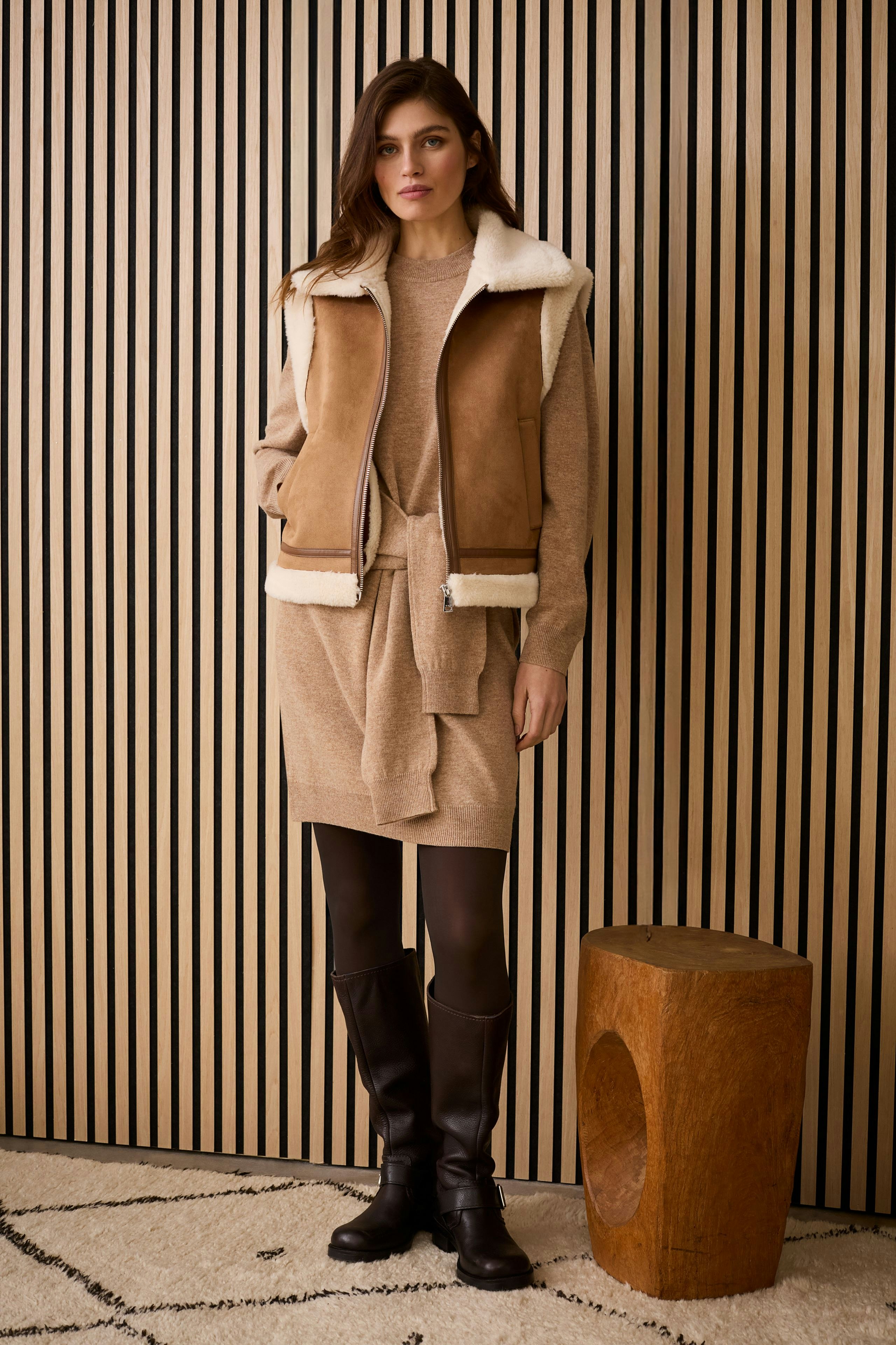 Casual women's vest: A woman in a brown vest with a soft collar, paired with a cozy outfit.