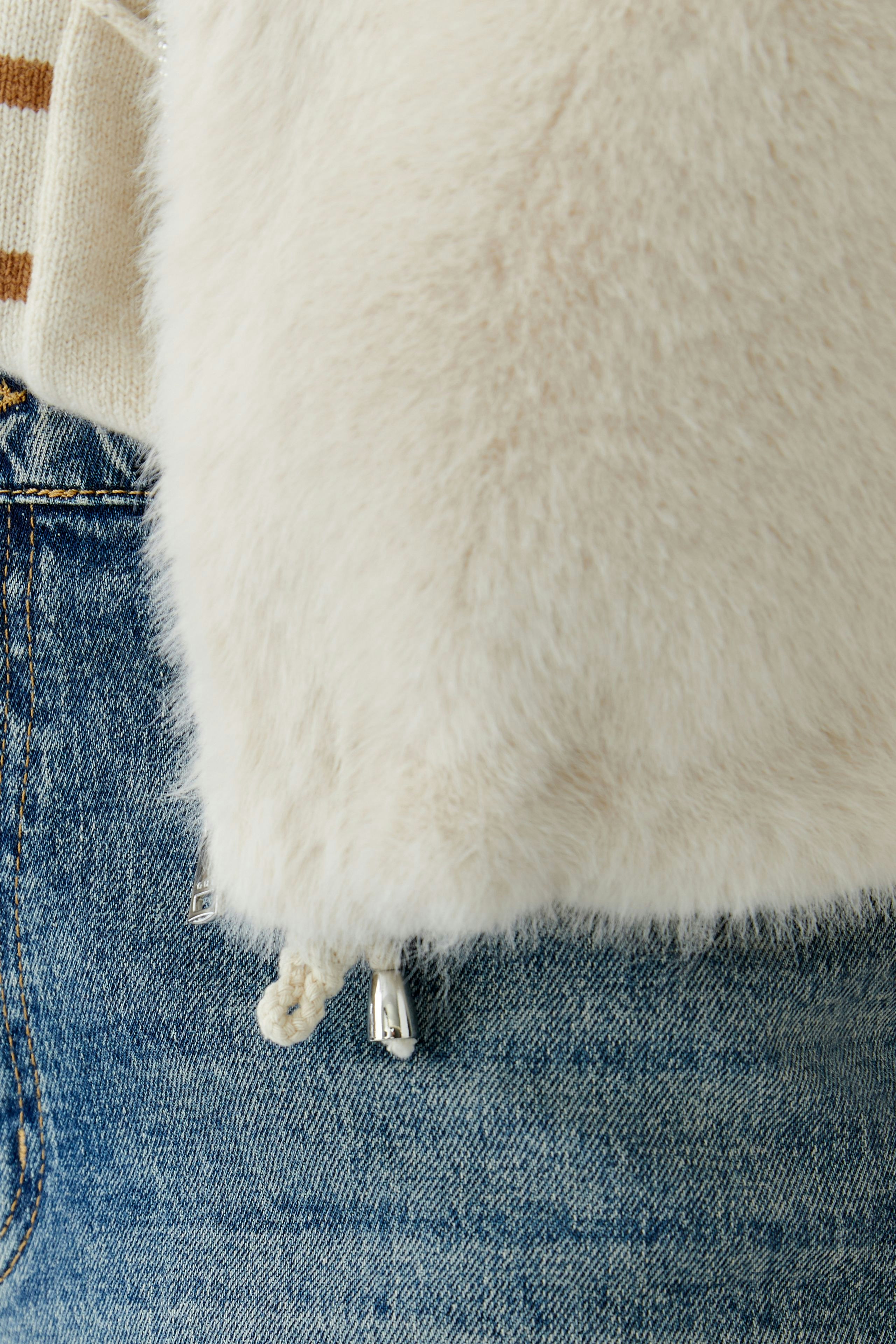 Cozy women's vest in soft faux fur, styled with a casual outfit.