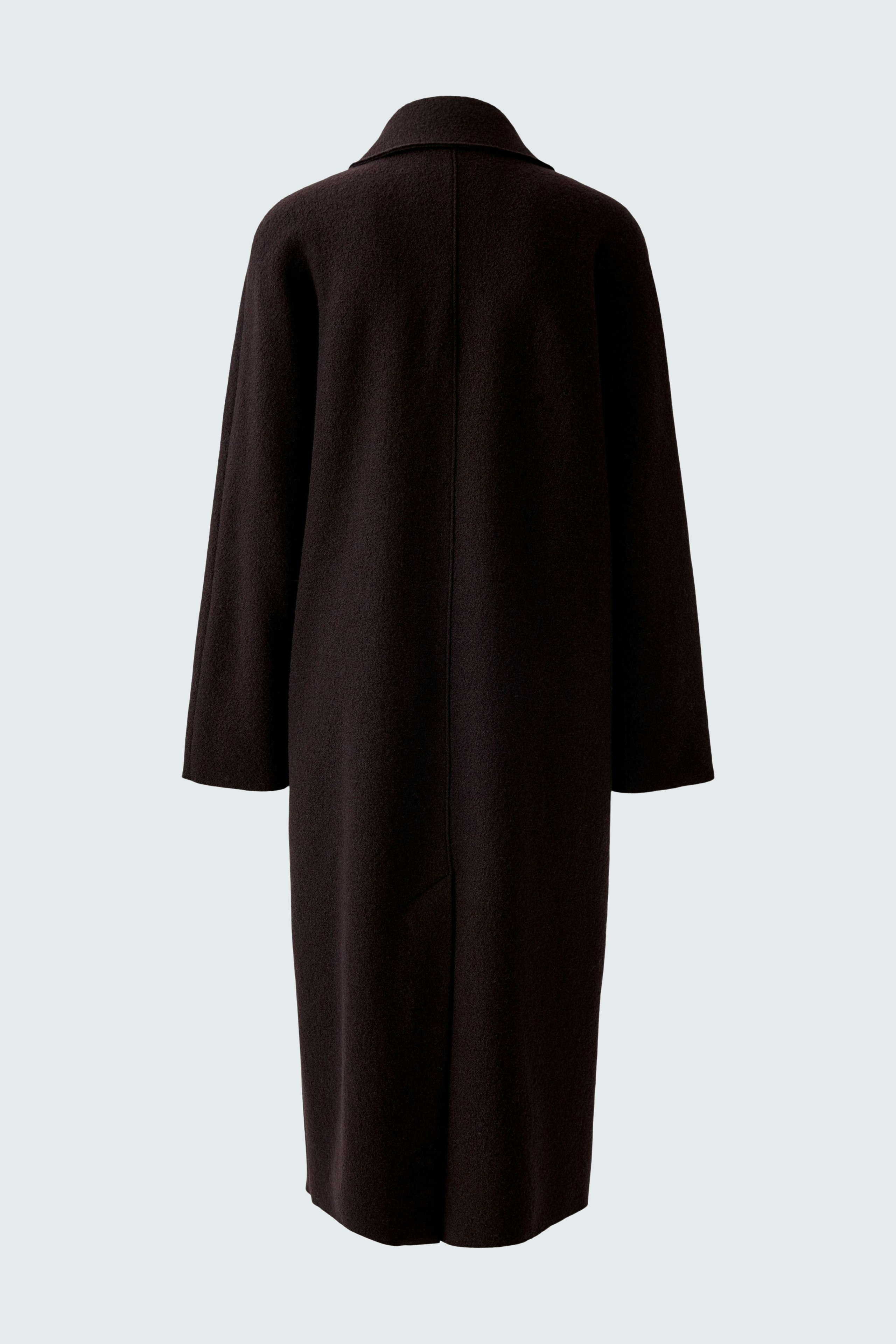 Casual women's winter coat: A woman in a long, dark coat with a relaxed fit, perfect for cold days.