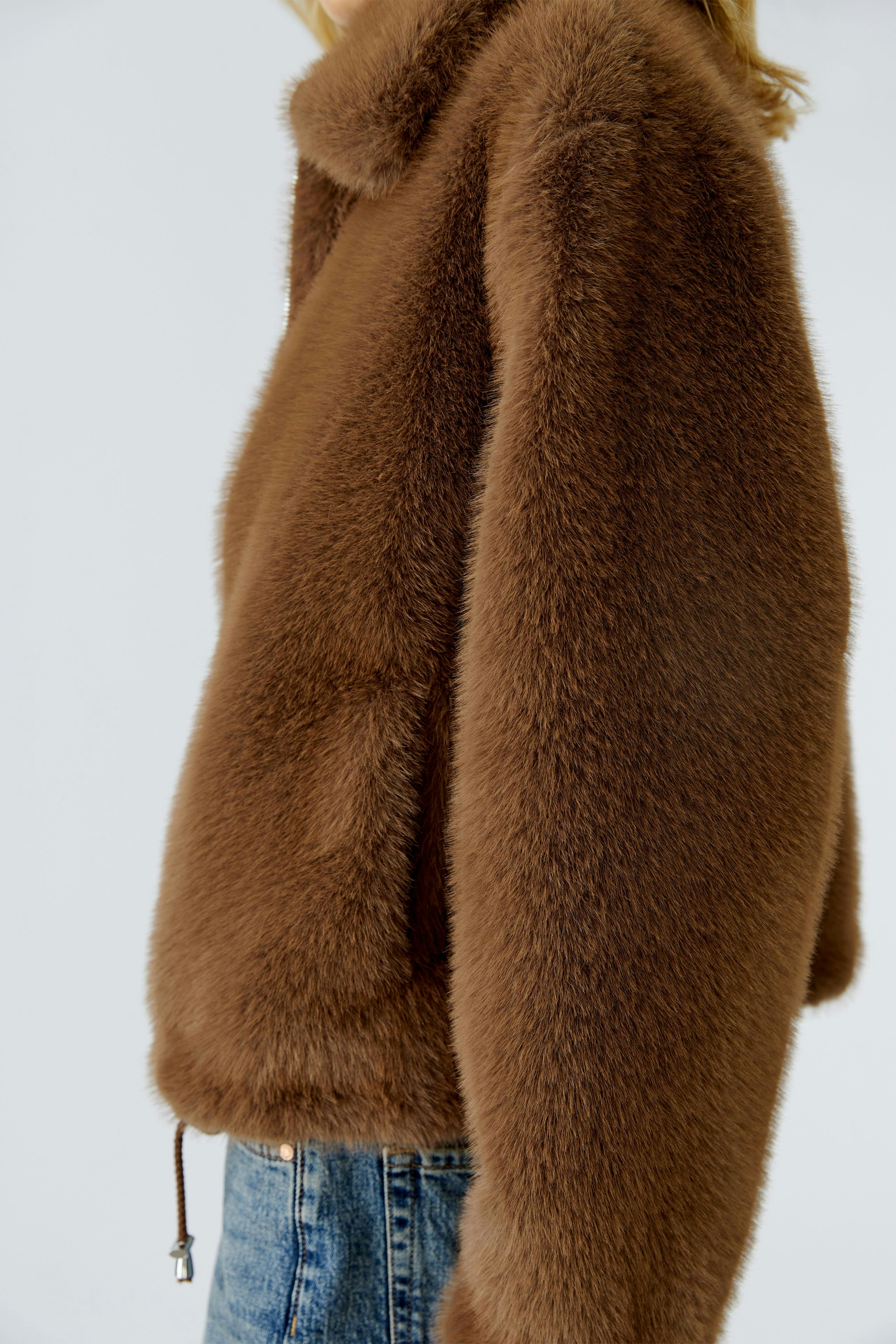 Cozy women's jacket: A woman in a soft brown jacket with a relaxed fit and a casual style.